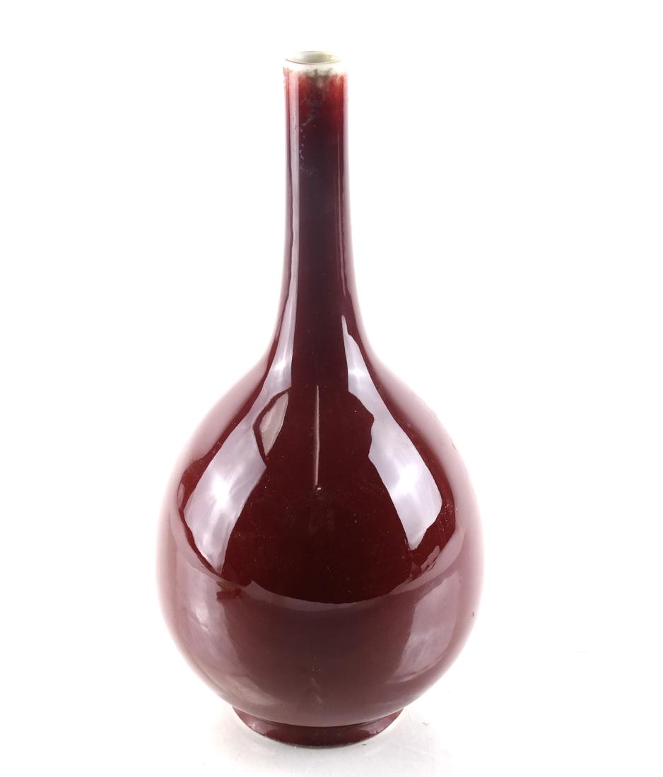 Chinese Porcelain Sang de Boeuf Vase: Porcelain sang de boeuf red bottle vase. 20th century. Dimensions: 10" H x 4.5" ⌀; 