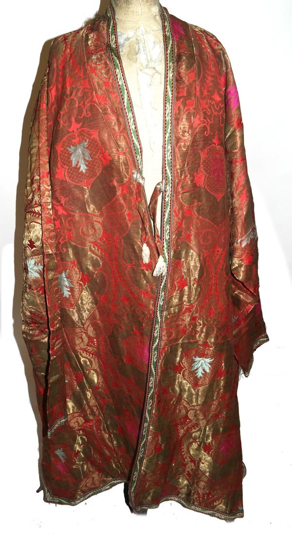 Central Asian Antique Men's Wedding Robe: Central Asian antique men's wedding robe with gold thread brocade, and antique ikat lining. 19th century and later. Dimensions: Base Of Neck To Hem - 52.5" L ; 