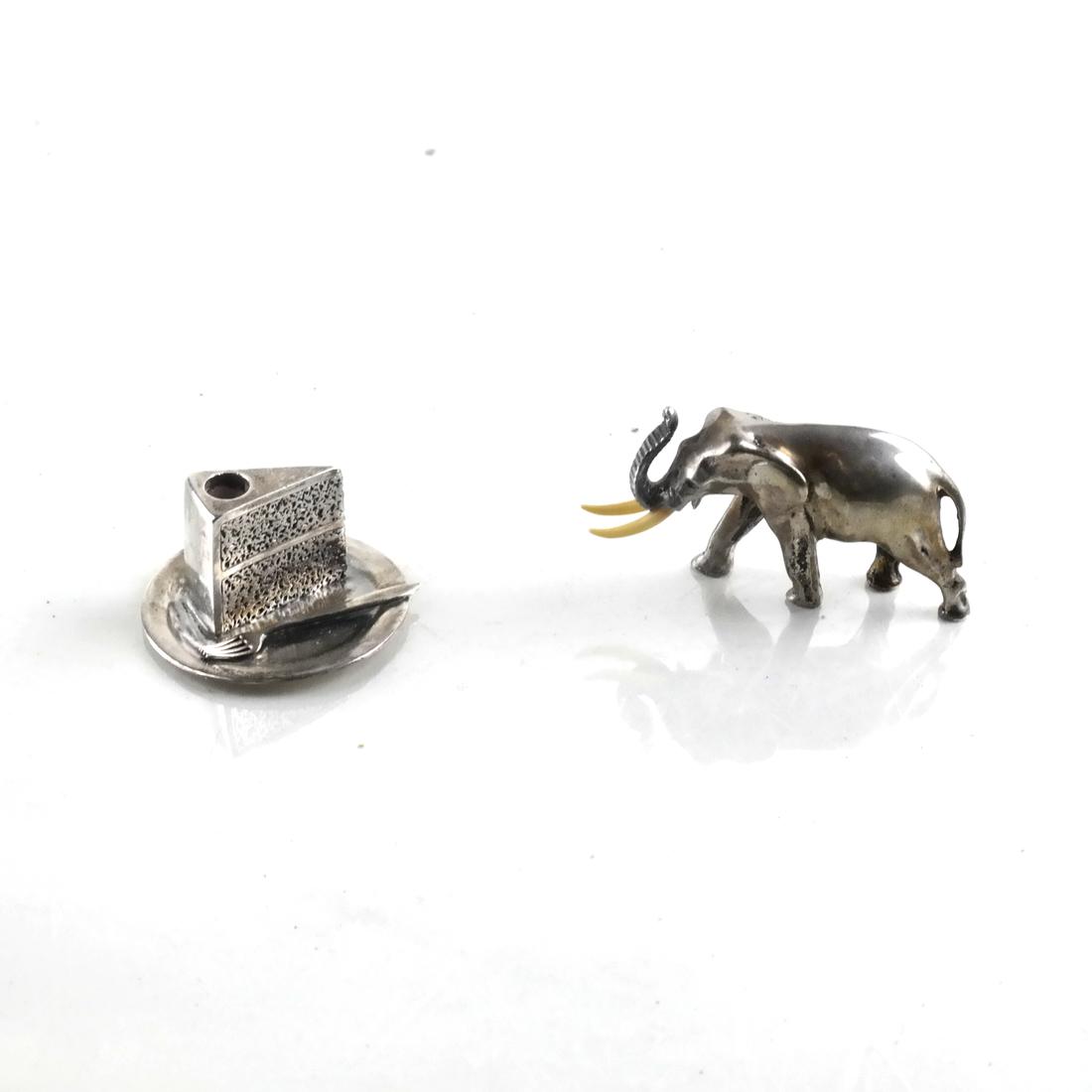 German .800 Silver Sculpture of an Elephant, Others: Comprises an .800 silver sculpture of an elephant, and a silver plate candlestick modeled as a piece of cake on charger with a fork. Unmarked. .785 ozt. Dimensions: Elephant - 2.5"