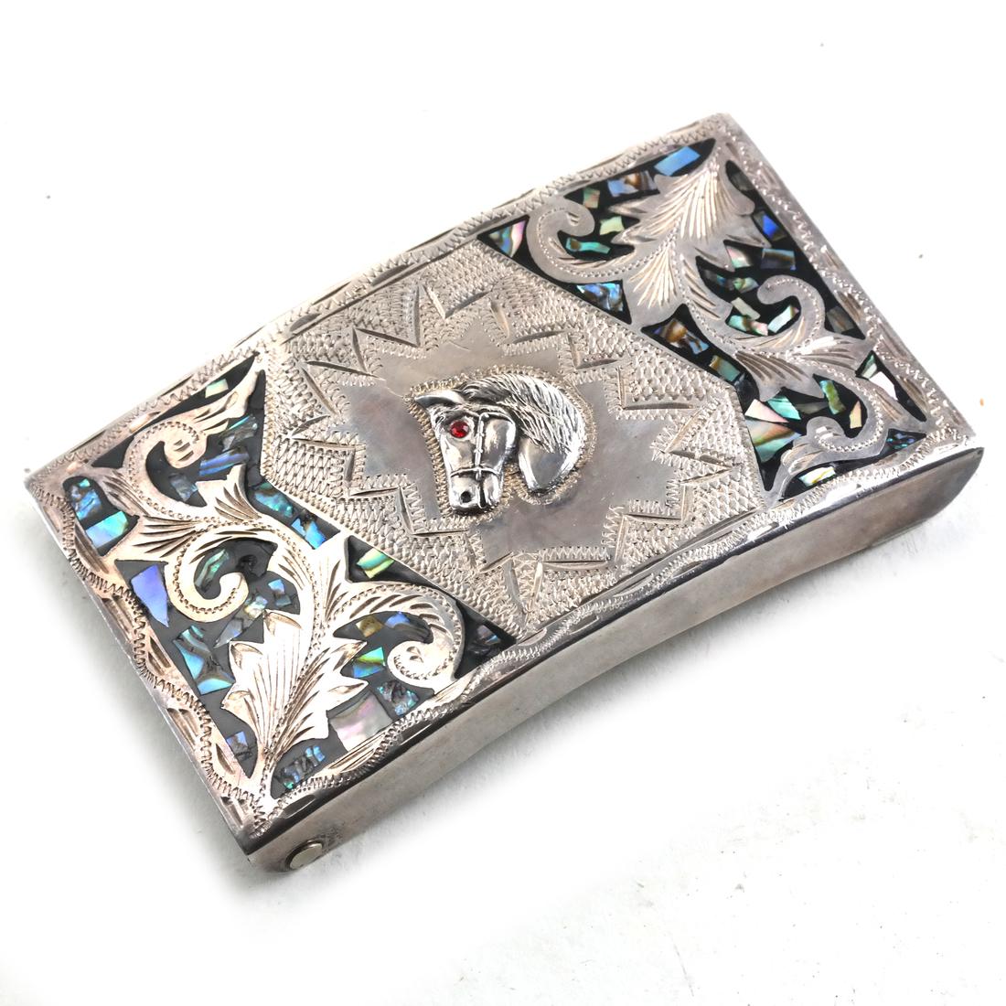 Mexican Sterling Silver Belt Buckle: Mexican sterling silver and mother-of-pearl belt buckle, with ruby point eye. Marked 'EGO' to underside. Total weight 1.950 ozt. [3/4 x 3 1/2 x 2 1/8 inches].