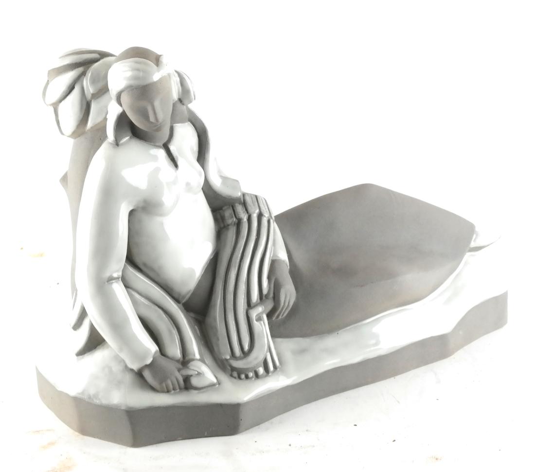 Phoenix Art Deco-Style Female Sculpture: A two-tone ceramic sculpture of a reclining woman, marked "Phoenix" underneath. [9 1/2 x 13 x 5 inches].