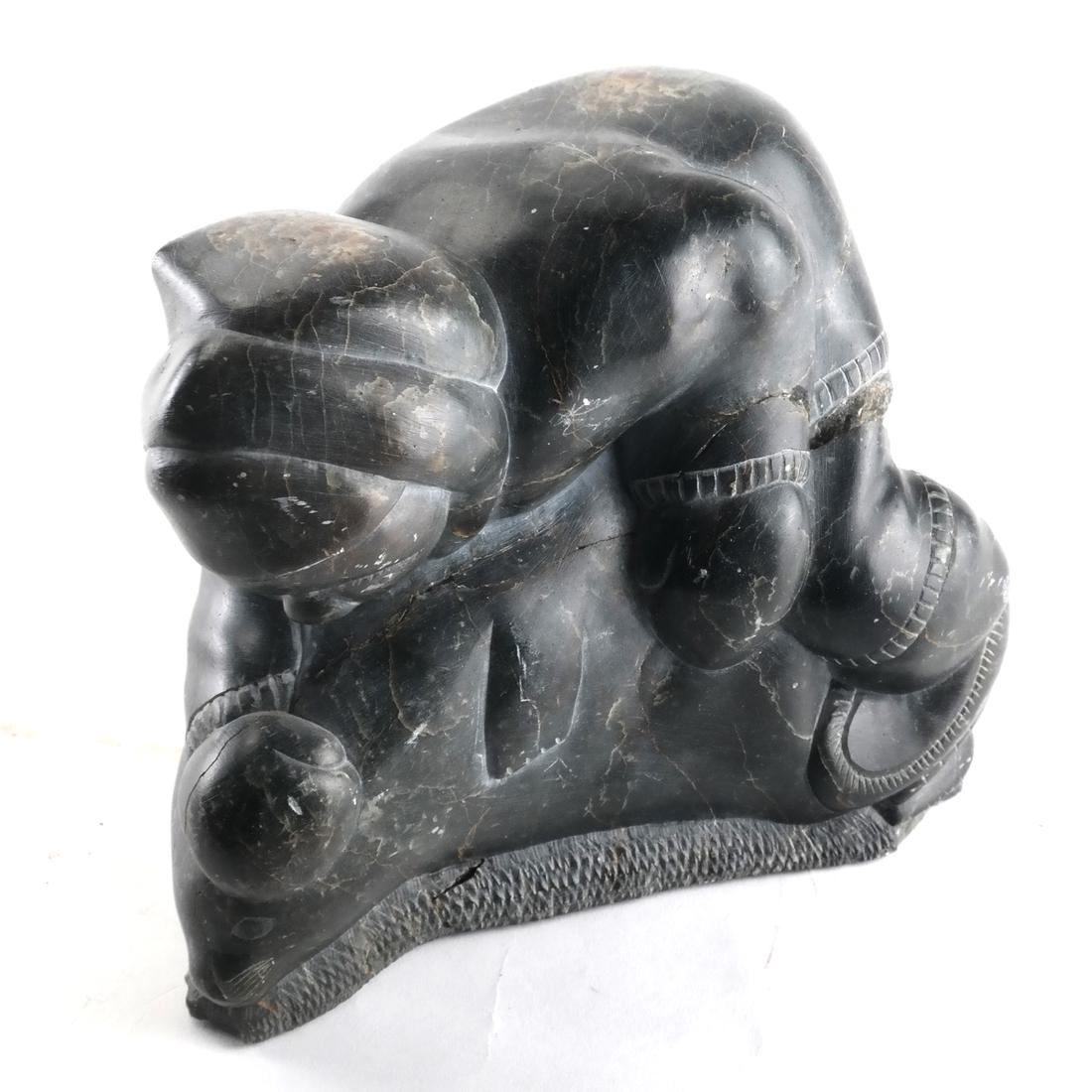 Inuit Sculpture of Hunter & Seal: Inuit sculpture of a hunter and seal, with inscription underneath. [7 3/4 x 7 1/2 x 4 inches].