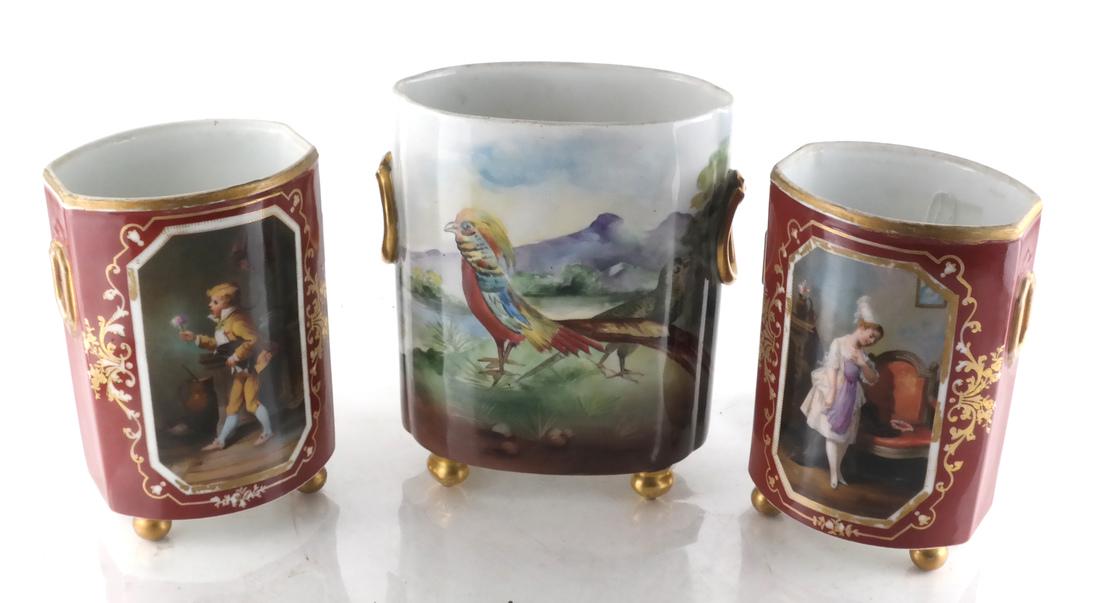 3 French Porcelain Vases, (One Limoges): Three footed porcelain vases, all decorated. 1) A Limoges landscape and bird vase, 2) a pair of opposing figural decorated vases. [Limoges: 9 x 7 x 4 inches; Unmarked: 8 x 5 x 4 1/4 inches].