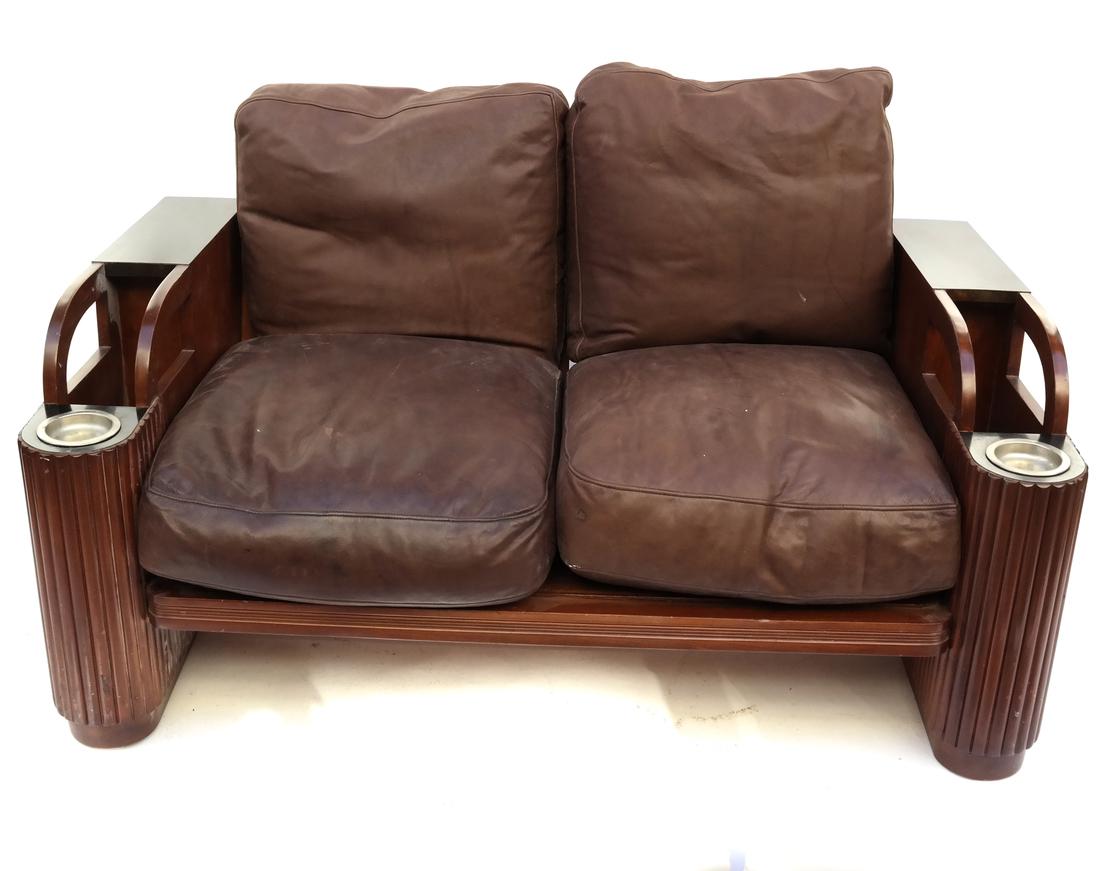 Art Deco Settee: Art Deco reed and curved form settee with aluminum ashtray inset and four brown leather slip cushions. In overall good condition.