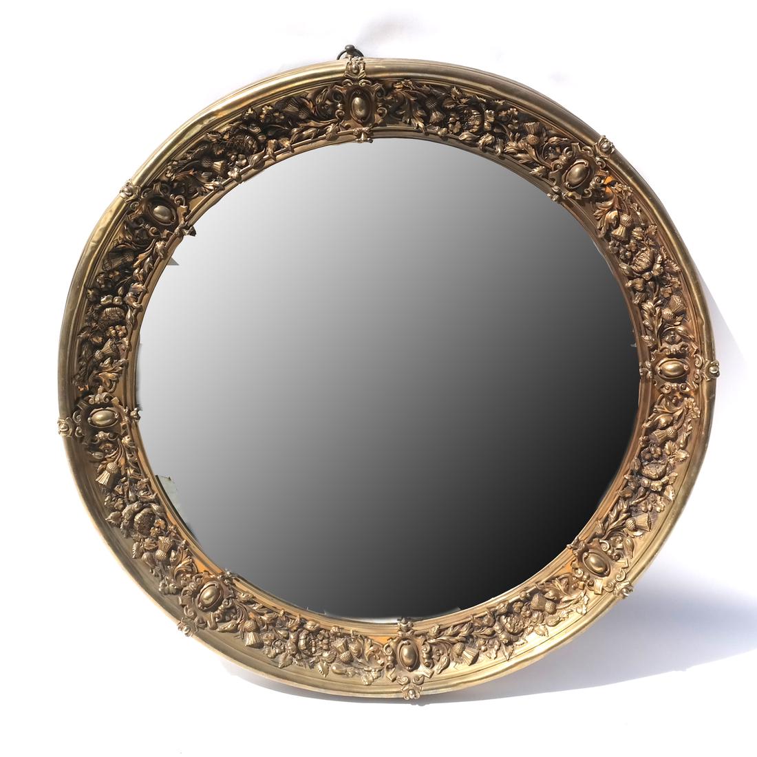 Metal Moulded Brass Roundel: English Victorian sheet metal moulded brass roundel inset with mirror, the rim border with thistle, rose, acanthus, and beads in reserves. Unsigned. Circa 1885. [34 3/4 (dia) x 2 inches]. Light dents 