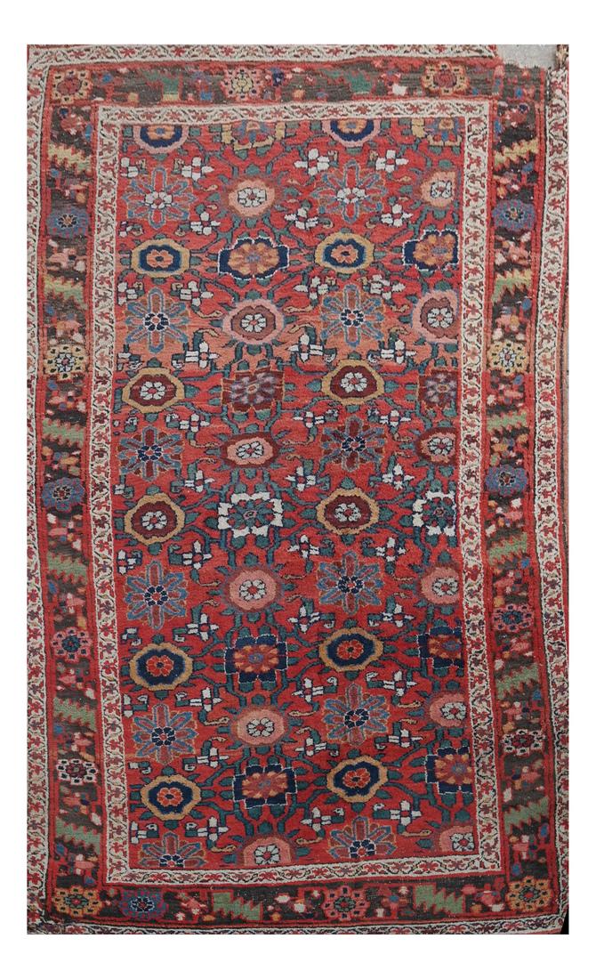 Central Asian Heriz Rug: Central Asian Heriz rug. [4 feet 5 inches x 8 feet 5 inches]. Tear to a corner, wear and discoloration.