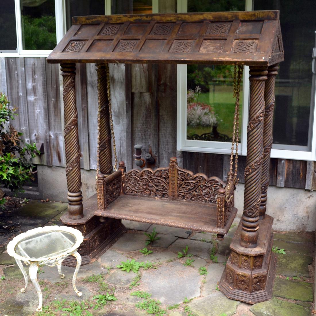 Antique Balinese-Style Swing: Balinese-style ornate frame and swing. [Frame: 89 x 82 x 42 inches; Swing: 18 x 48 x 21 inches]. In good condition. Item has been restored and wood is darker than shown in picture.