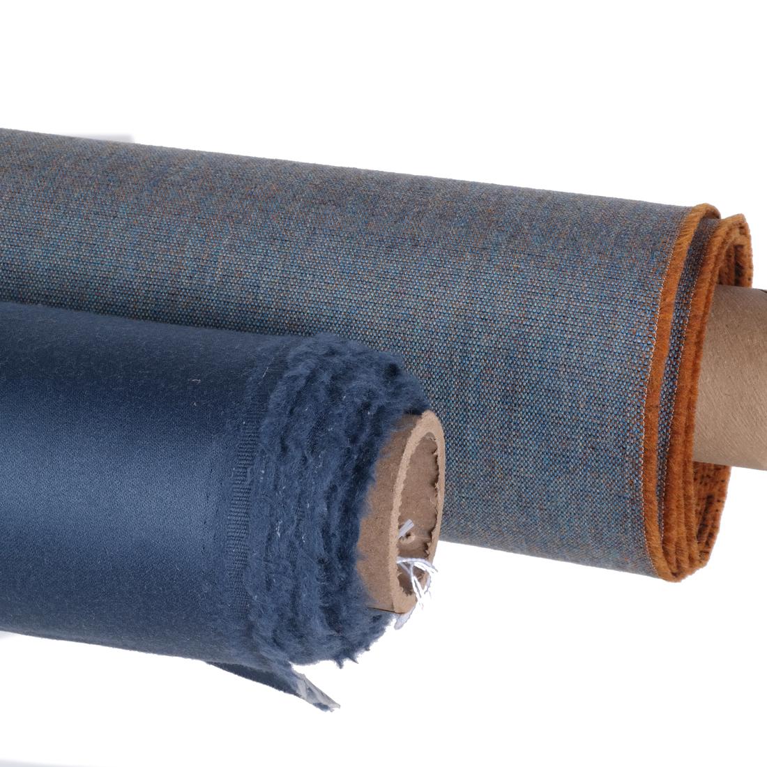 Blue Fabrics: Holland & Sherry and Maharam: Comprises: 1) 7 1/2 yards of Holland & Sherry's super-fine worsted wool warp satin in blue, #DE10463, "Glace". Approx. width of 60". 2) 12 1/4 yards of Maharam's 90% worsted wool and nylon, "Canvas", 