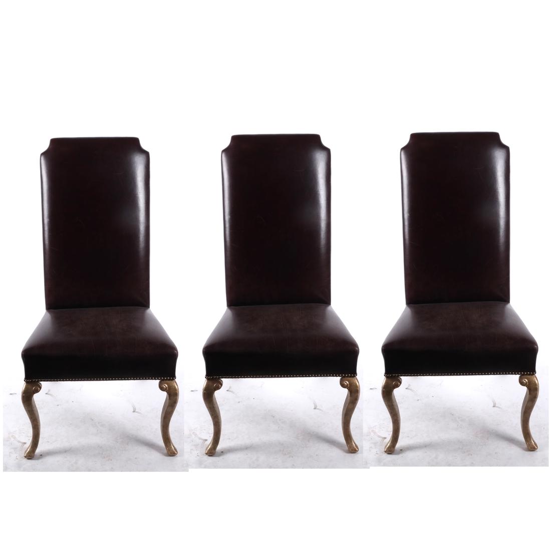 Manner of Holly Hunt: Six Dining Chairs: Six dining chairs in the manner of Holly Hunt. Brown leather upholstery with gilt-tone legs. [45 x 24 x 26 inches; 18 inches to seat]. Scuffs, paint loss.