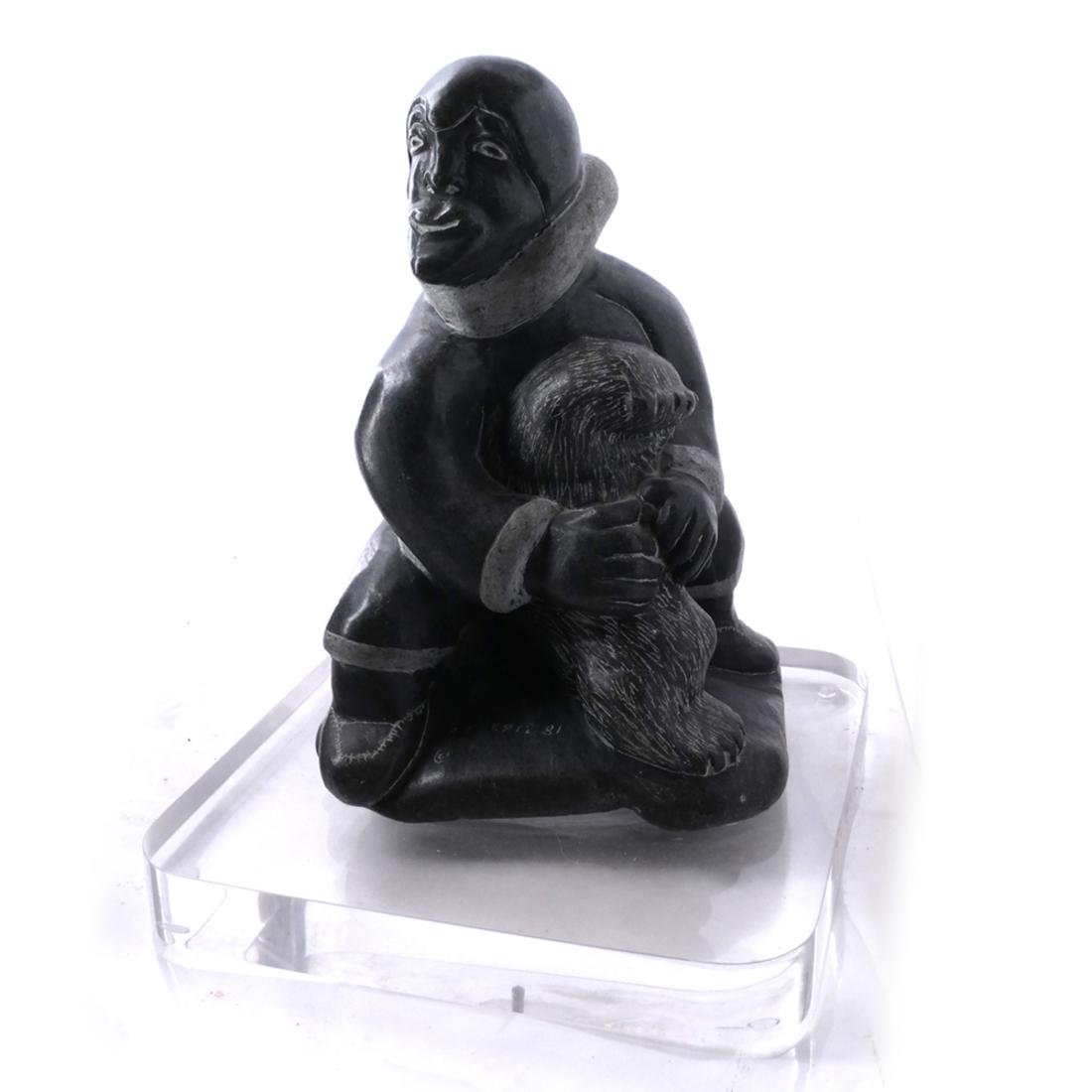Inuit Stone Sculpture of a Man: Inuit stone sculpture of a man. E9 1281. [Sculpture only: 11 1/2 x 7 x 7 inches].