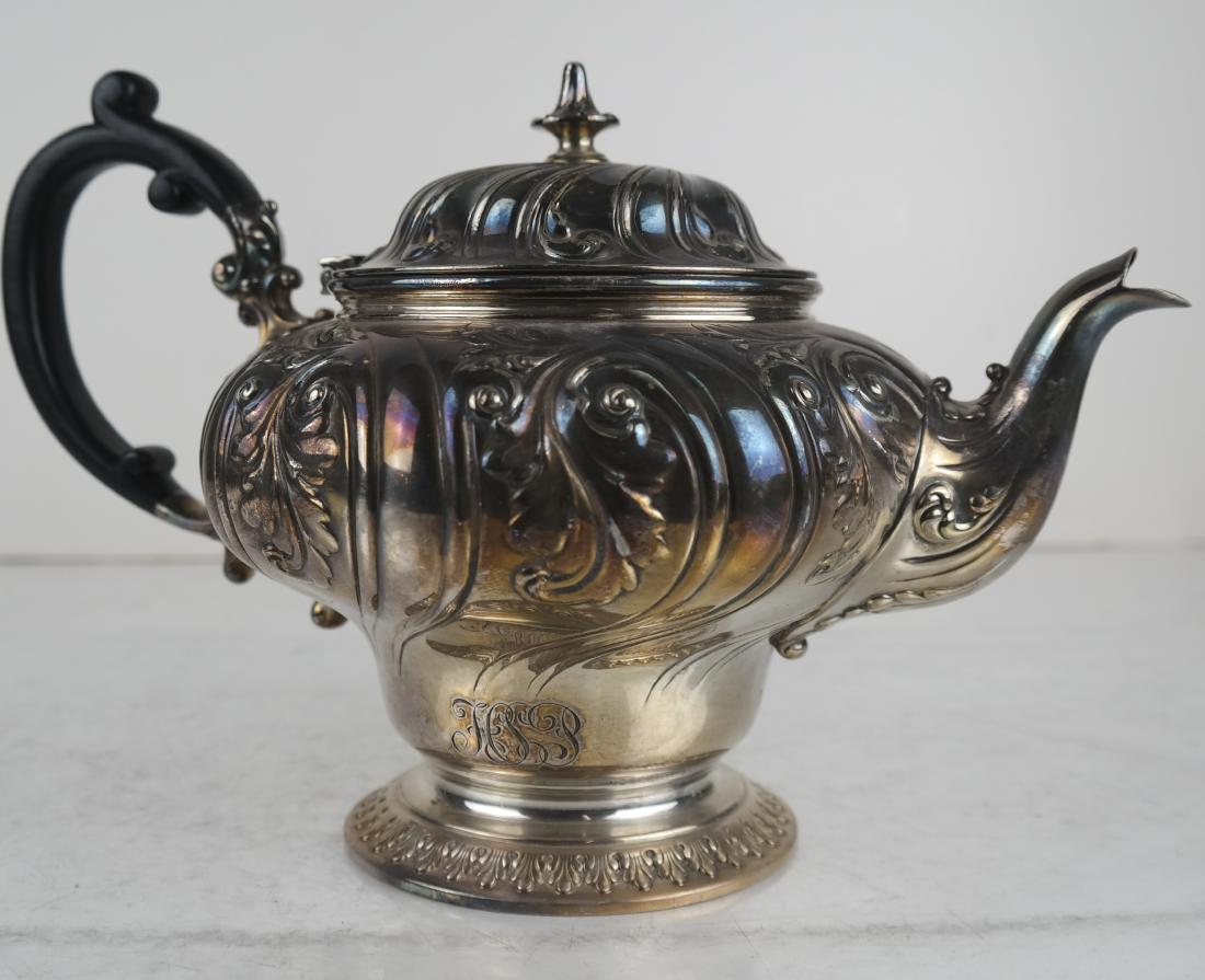 Tiffany & Co. Makers Silverplate Teapot: Tiffany & Co. Makers silverplate teapot (#2532-185-V 2/12 pint teapot on pedestal with swirling fluted and foliate chasing on body, hinged lid and nipple finial, with a wooden C-form handle. [6 1/2 x 