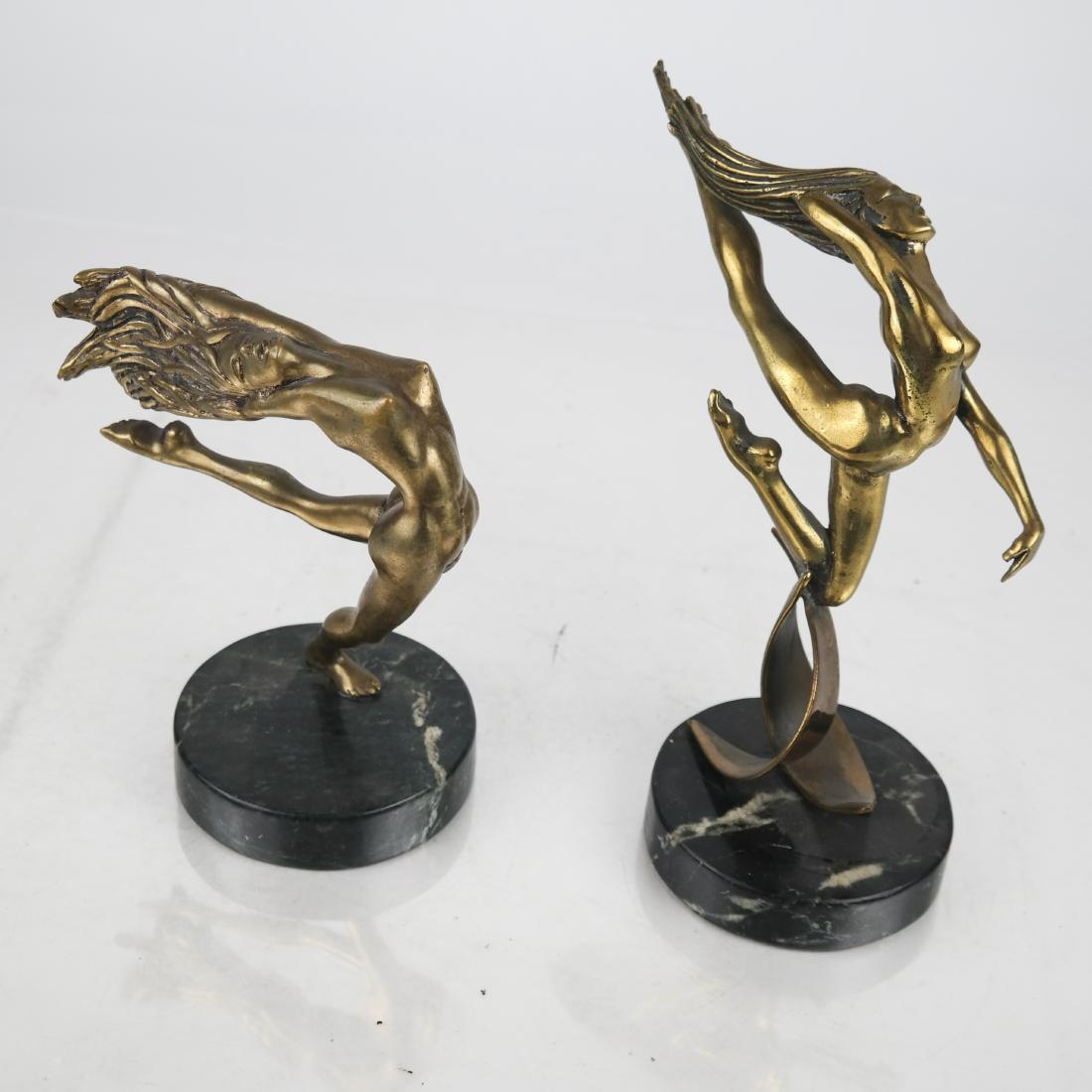 Tom BENNETT: Two Sculptures - Nudes: Two female nude sculptures of dancers, each on marble bases, Editions numbered 4/100 and 6/100. [9 x 4 (dia) inches; 7 x 4 (dia) inches]. Patina wear.