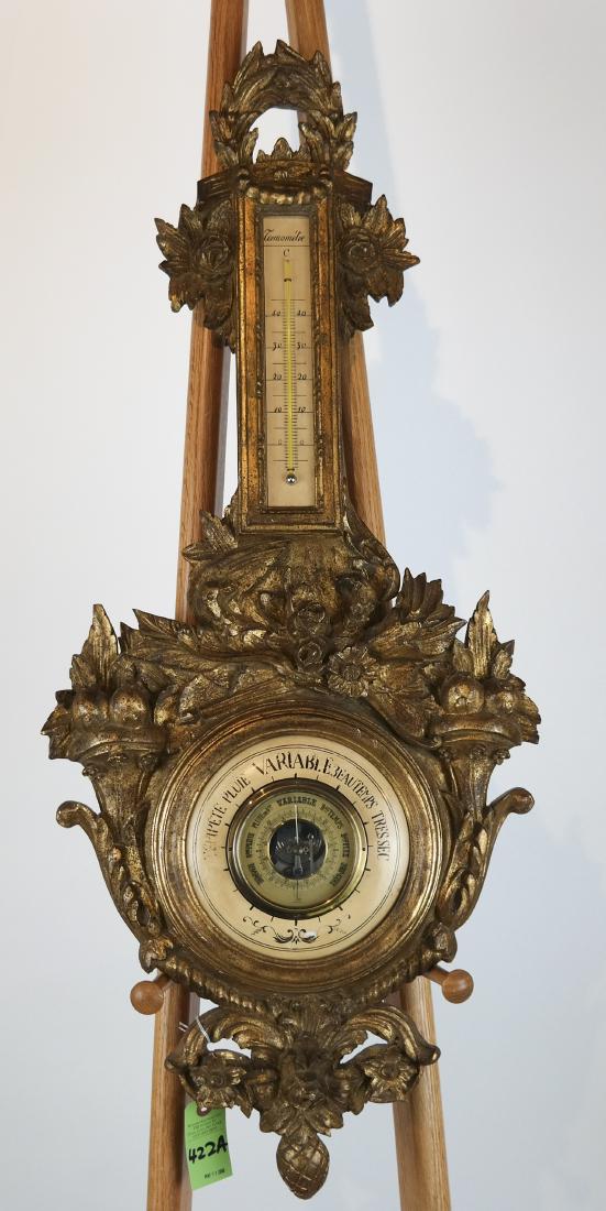 Louis XVI-Style Gilt Wood Barometer: Louis XVI-style gilt wood barometer, with floral, bird and ribbon carved designs. [3 1/2 x 39 x 16 inches]. In good condition.