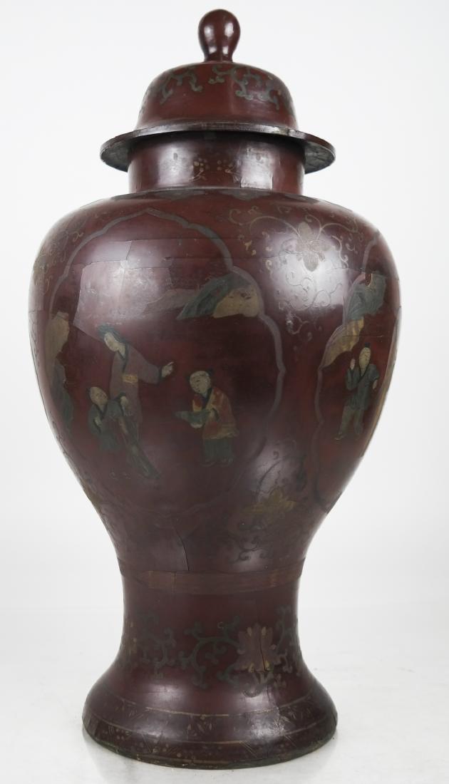 Chinese Lacquer Covered Ginger Jar: Chinese brown lacquer covered ginger jar, painted with figural and garden scenes, surrounded by floral scrolling and brocade designs. [20 1/2 x 11 (dia) inches]. Cracks, losses, splits, soiling, wear 