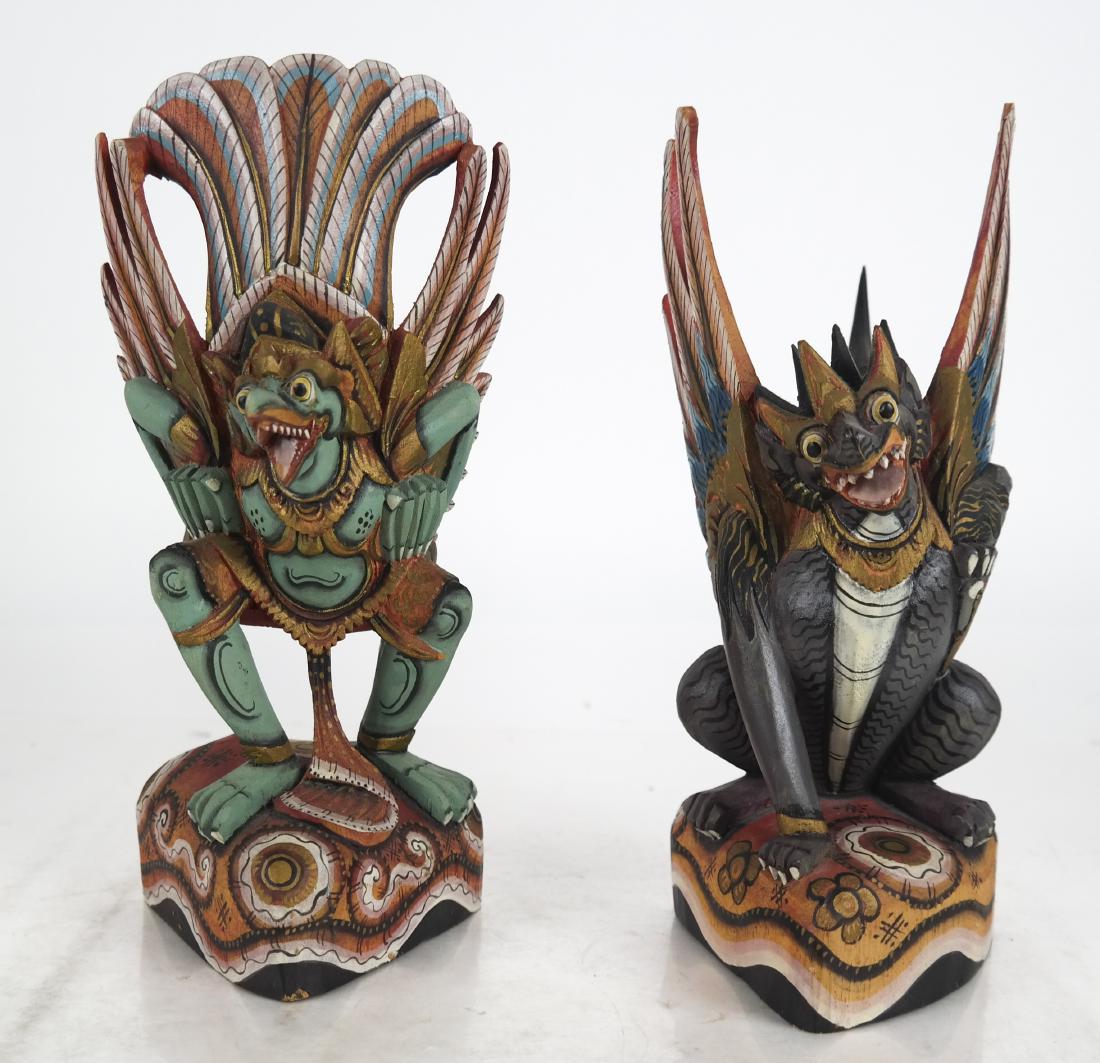 Pair of Indonesian Carved, Painted Demons: Pair of Indonesian carved and painted demons, with wings and feathers. In good condition.