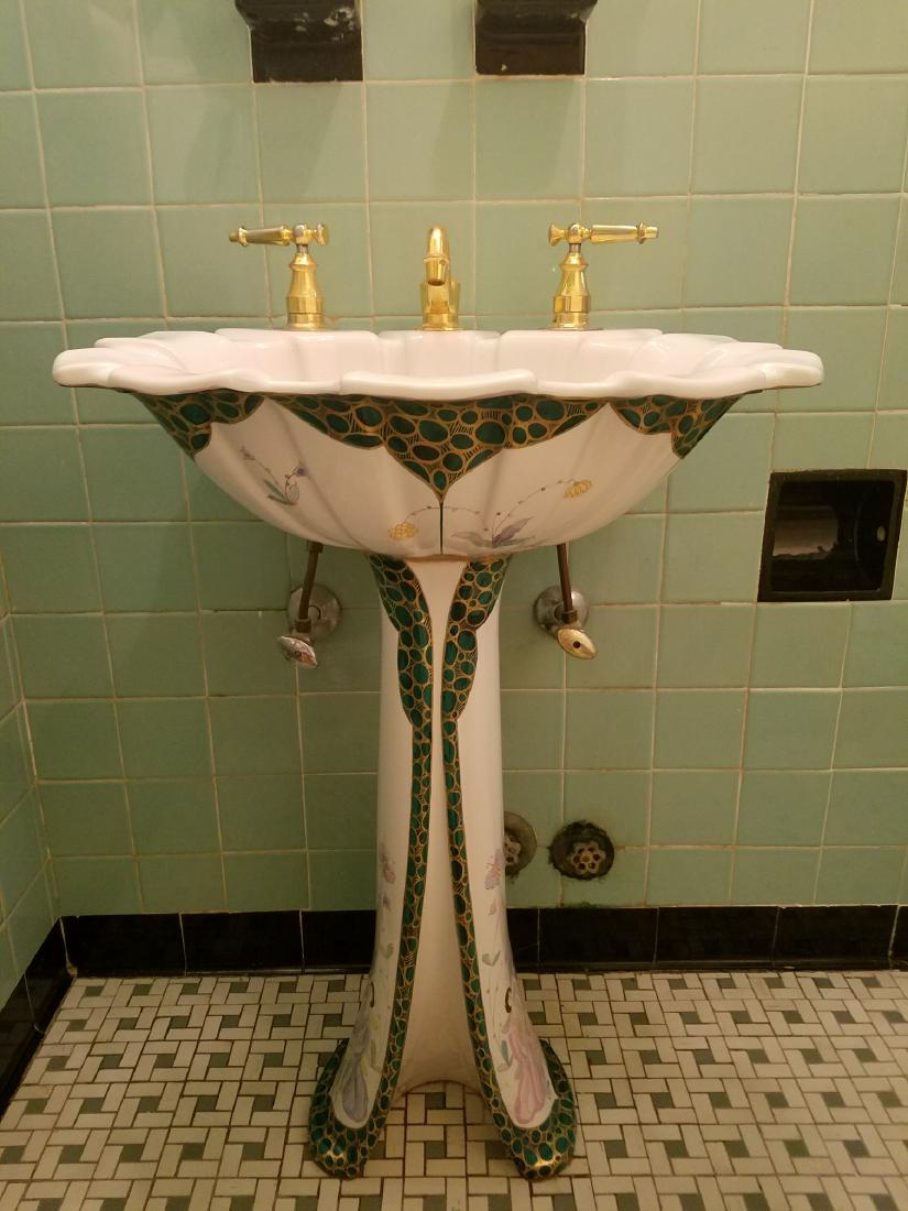 KOHLER Pedestal Sink - Chinoiserie Design: Kohler pedestal sink with scalloped bowl and gold tone hardware, in Chinoiserie design. One side with a repair.