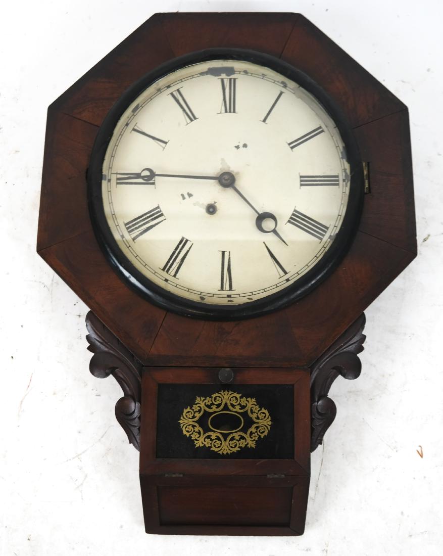 Victorian Wall Regulator Clock: Victorian wall regulator clock with a reverse painted lower door and metal face. [24 x 17 1/2 x 3 inches]. Metal face with wear.