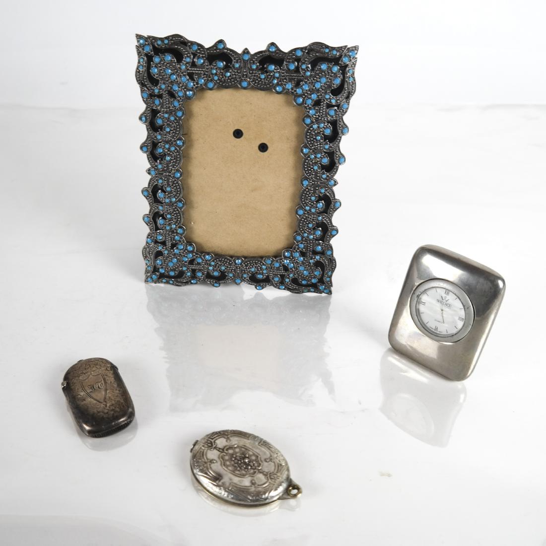 Wallace Silversmiths Clock & 3 Others: Two silver compacts, a decorated photo frame and a miniature silver plate desk clock by Wallace.