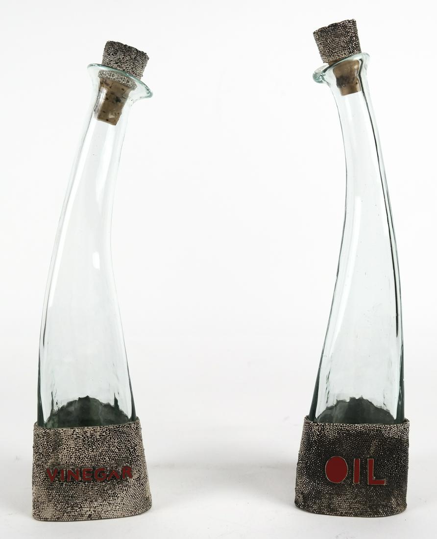 Art Deco-Style Oil & Vinegar Bottles: Pair of mid-20th century Art Deco-style glass oil and vinegar bottles. Chip at rim of one bottle.
