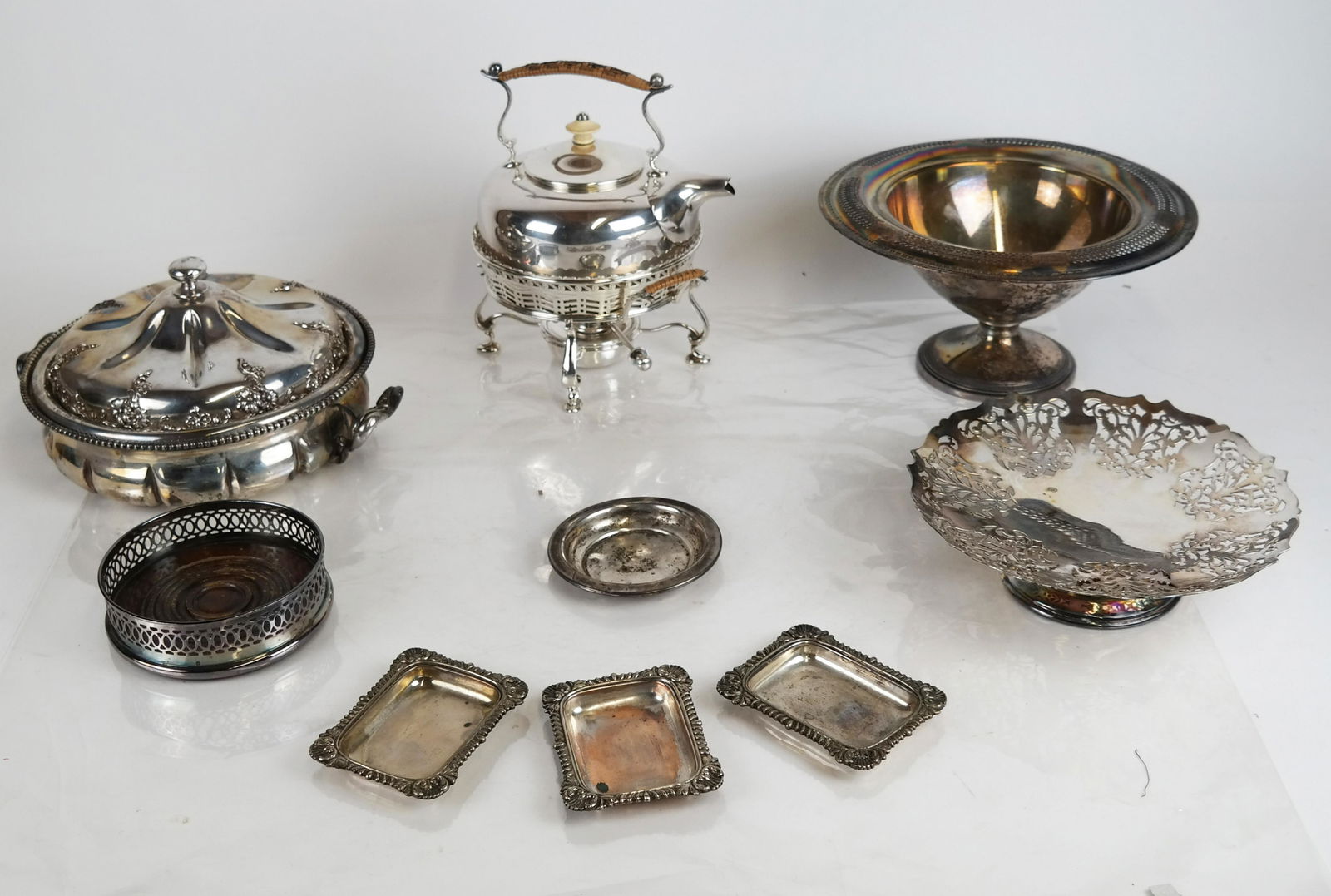 Group of 8 Silver Plate Items: Lot of English silver plate, including: a kettle on a stand [9 x 8 1/2 x 6 inches]; and a tureen with lid [5 x 9 (dia) inches], a wine coaster, Mappin & Webb, three nut dishes and two reticulated tazz