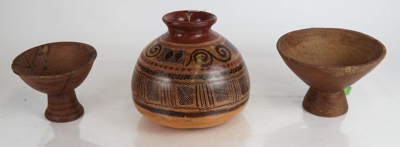 3 Mayan/Pre-Columbian-Type Pottery Vessels: Earthenware vase/olla, with sgraffito decoration in geometric designs [7 1/2 x 8 (dia) inches], in good condition, and two pottery pedestal bowls [5 x 8 (dia) inches; 4 1/2 x 6 (dia) inches], with chi
