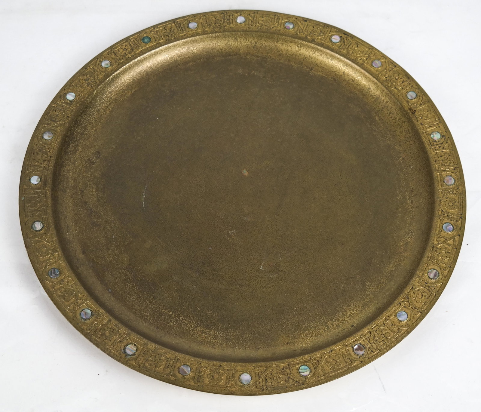 Tiffany Studios-Style Circular Brass Tray: Tiffany Studios-style circular brass tray, nacre embellished, unsigned. [24 x 14 (dia) inches]. Surface oxidation.