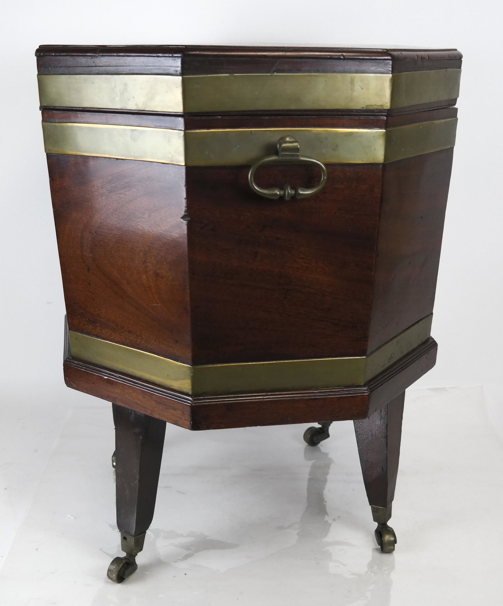 18th C. Chippendale Wine Cooler on Casters: 18th century English octagonal-form, brass-banded mahogany Chippendale wine cooler, on mahogany stand with casters [Overall: 23 x 19 (dia) inches]. In good condition.
