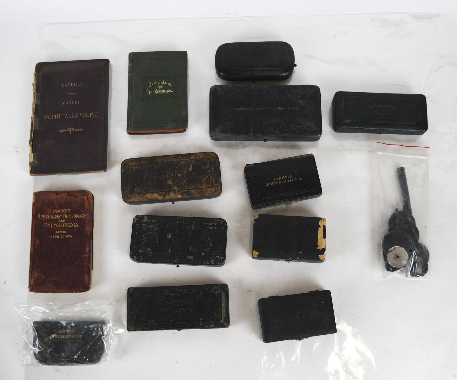 Lot of Ophthalmology Equipment: Includes 3 vintage books on ophthalmology and vintage scope lenses. In fair condition. Obvious wear on boxes. Some losses.