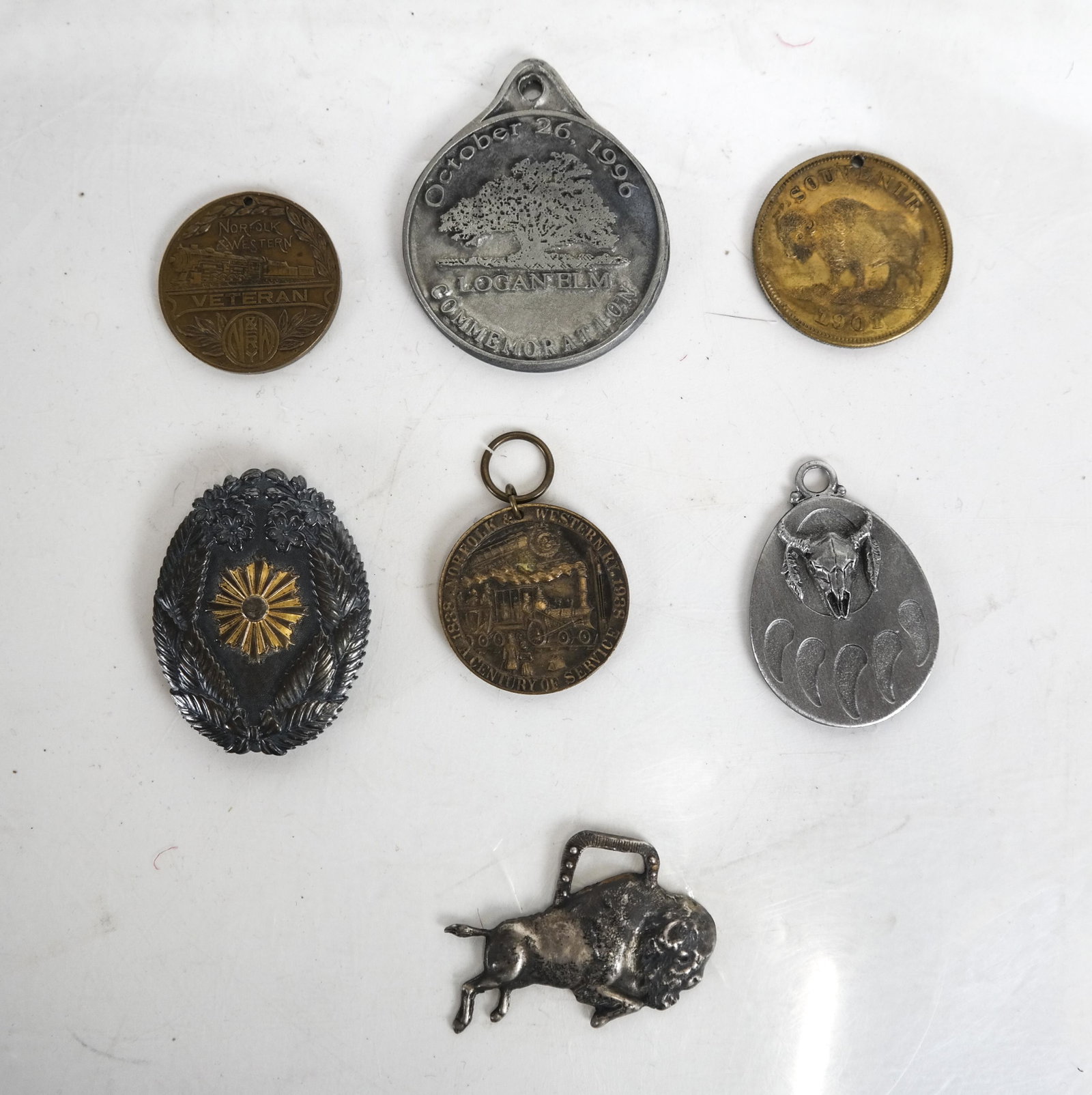 Lot of 7 Americana Medals and Pins: Assorted group of Americana pins, including "Who Will Mourn For Logan" (2), 1888-1938 Western Norfolk Rail Veteran (2), 1901 Pan American Exposition, Buffalo, NY, and a longhorn buffalo mixed metal fl