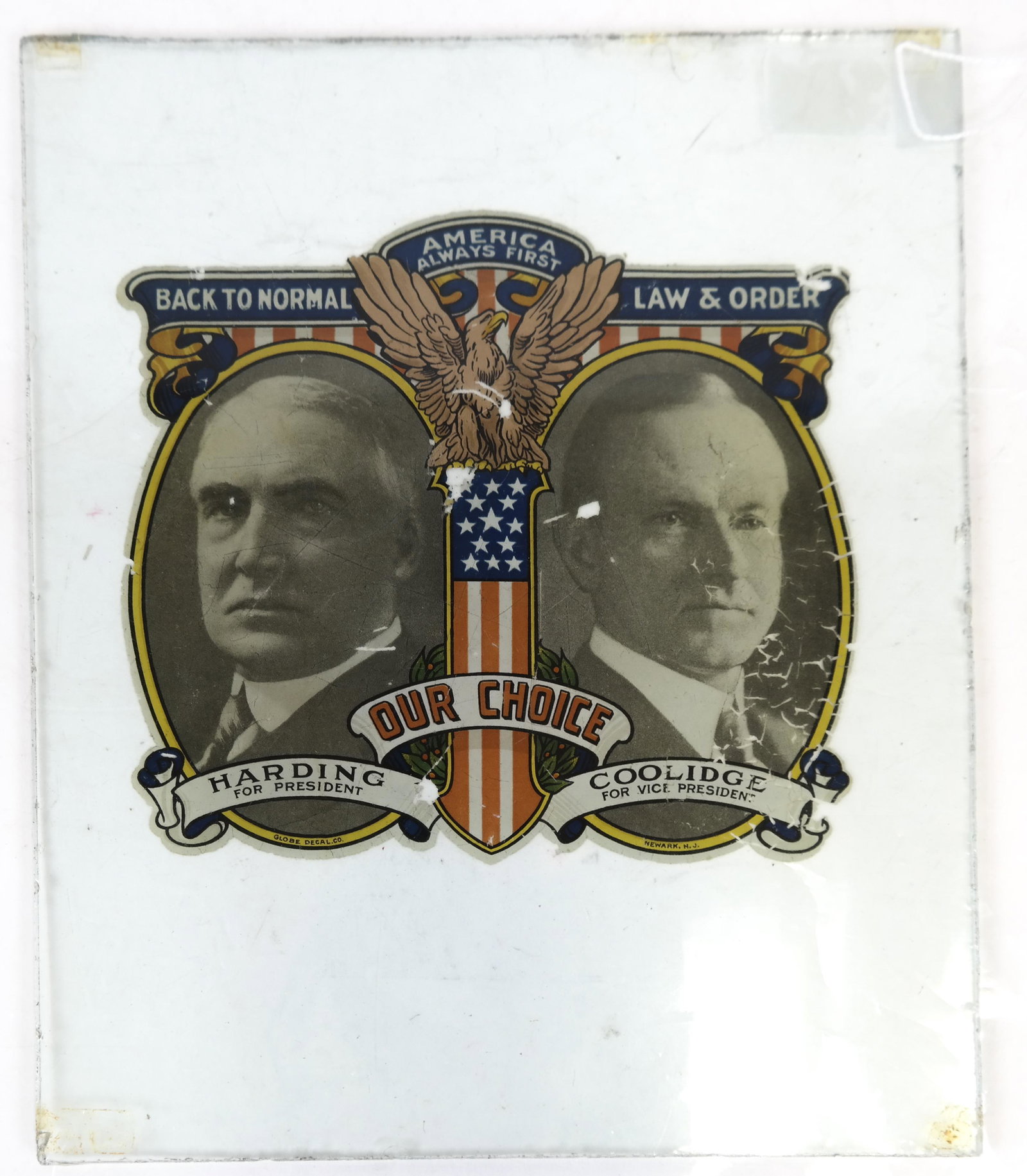 Harding & Coolidge Jugate Decal: Colorful decal "America Always First" depicting Harding and Coolidge side by side, mounted on glass. [10 1/2 x 8 1/4 inches].