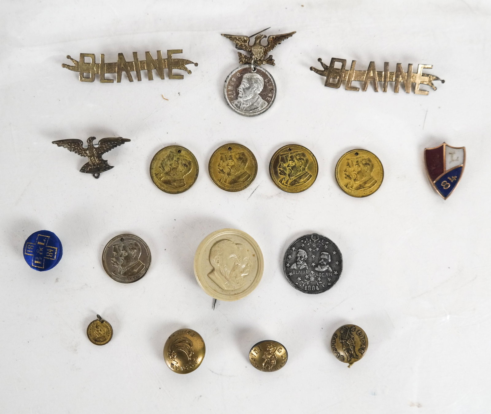 16 Total Blaine and Blaine/Logan 1884 Items: Sixteen total items, including: six jugate Blaine/Logan tokens, one featuring White House reverse; one unusual jugate with pin (possible vegetable ivory); two Blaine name badges; unusual "Blaine/Logan
