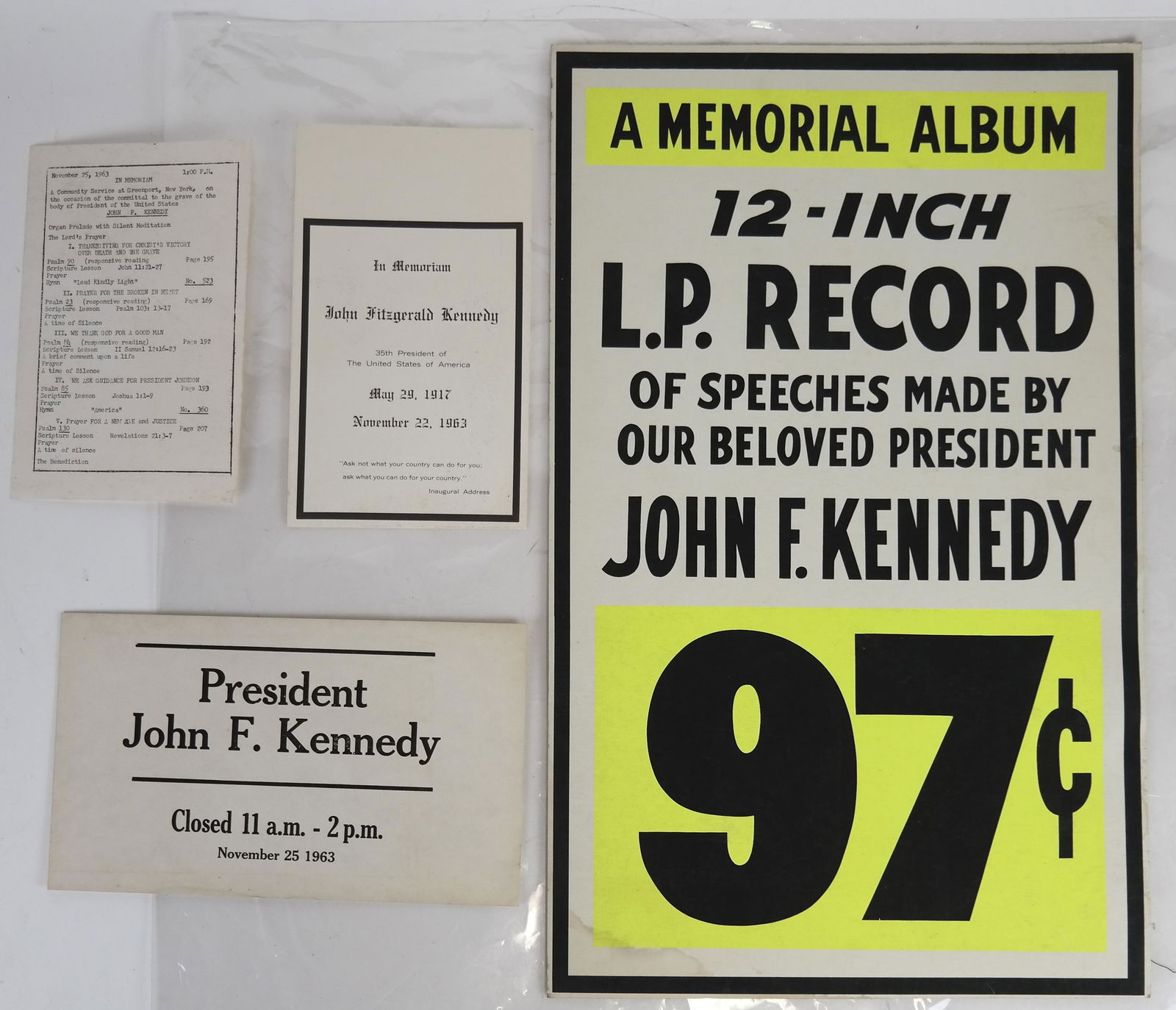 Lot of JFK Advertising Poster, Funeral Cards, More: Lot includes a bright, fluorescent colored "Memorial Album" advertising poster [22 x 14 inches]; 17 duplicates of store closing hard cardboard JFK funeral cards [11 x 6 1/2 inches]; 12 duplicate "JFK