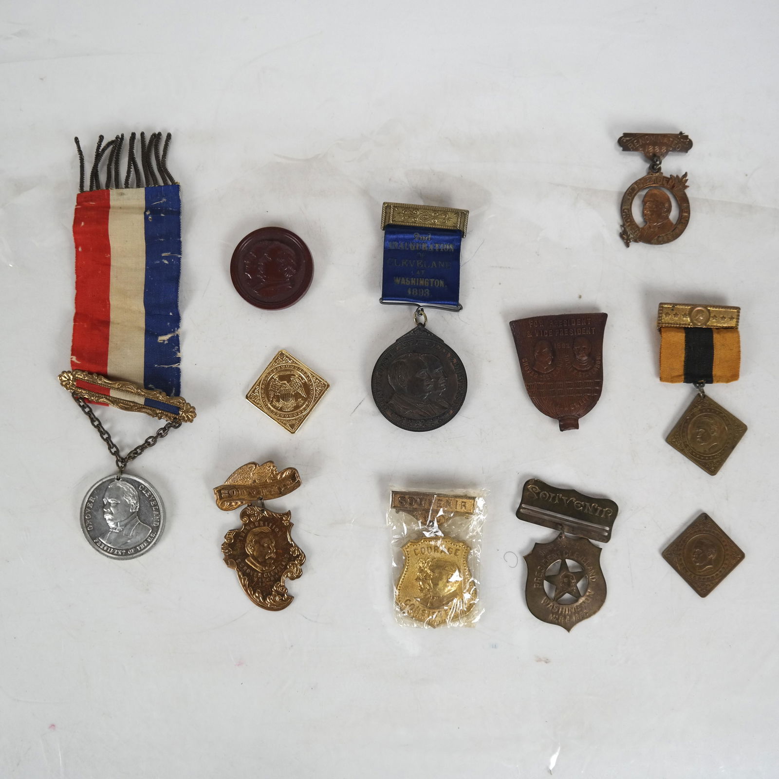 Lot Grover Cleveland Badges 1888/1893: Lot of eleven items, including: very scarce "Renominated 1888" badge topper with "Our President Grover Cleveland" imprint and profile image on obverse; Penfold, Buffalo NY imprint on reverse; three di