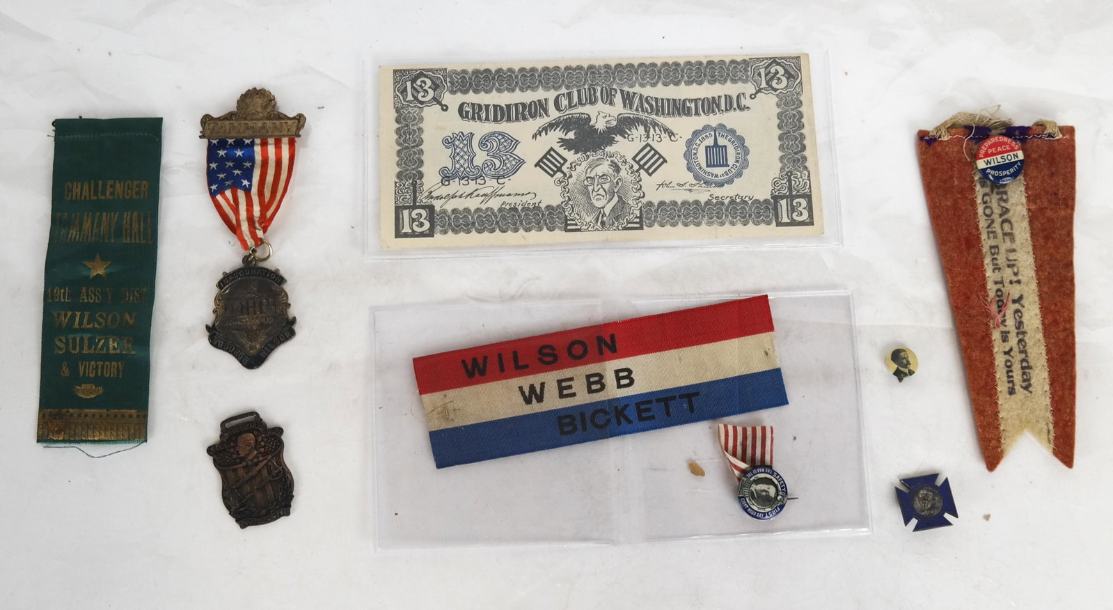 Woodrow Wilson Pinback, Ribbon, Paper Lot: Woodrow Wilson lot includes: Impressive, Wilson Tammany Inauguration Badge, Marc 5, 1917 with flag ribbon and featuring While House badge (G. Ryan & Co.) manufacturer Wilson/Webb/Bockett; Ribbon: Wils