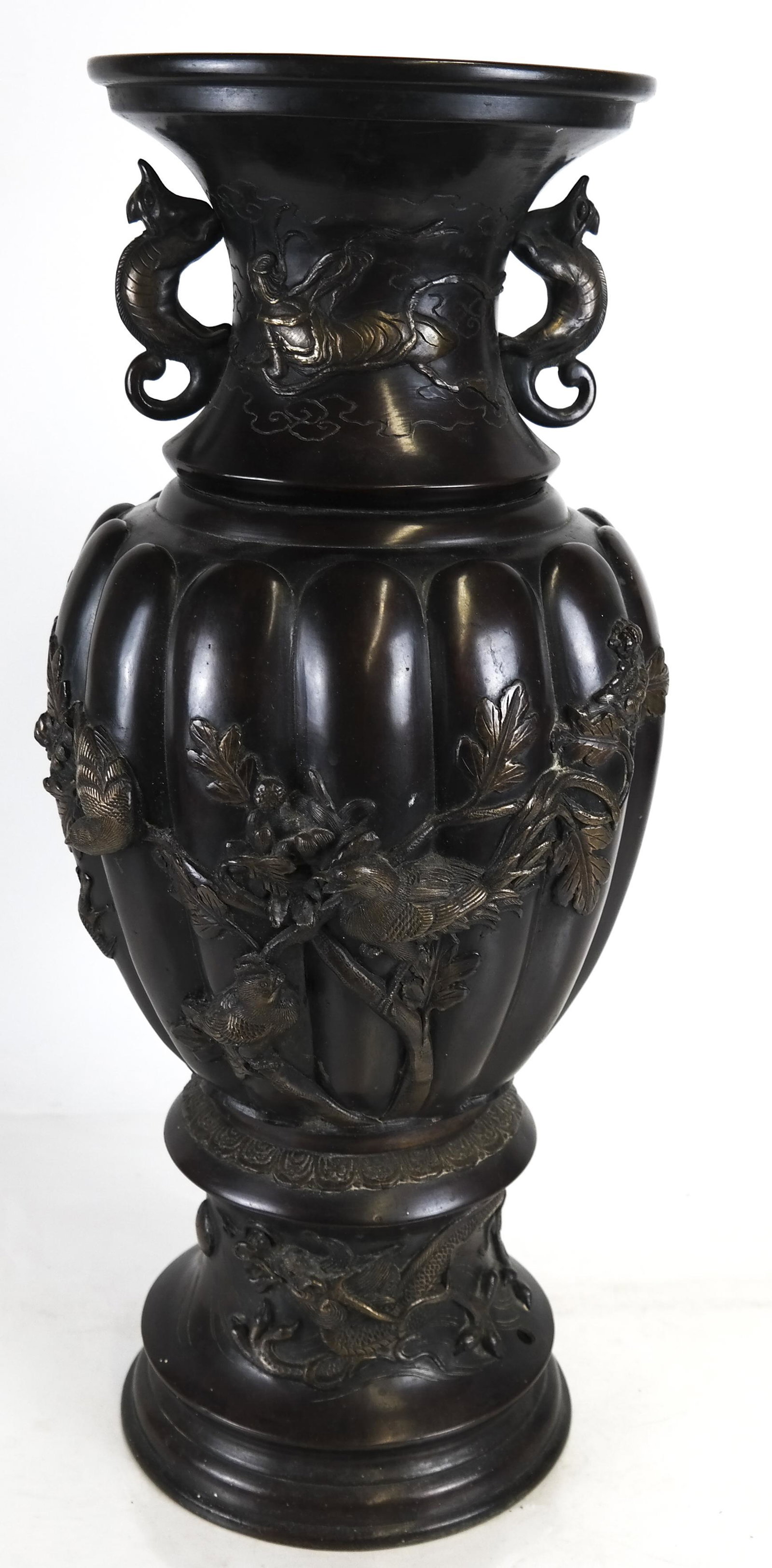 Japanese Meiji Period Bronze Vase: A Japanese Meiji period bronze patinated metal vase, of tapering baluster form, brass embellished, on a domical foot. [24 inches high]. In good condition.