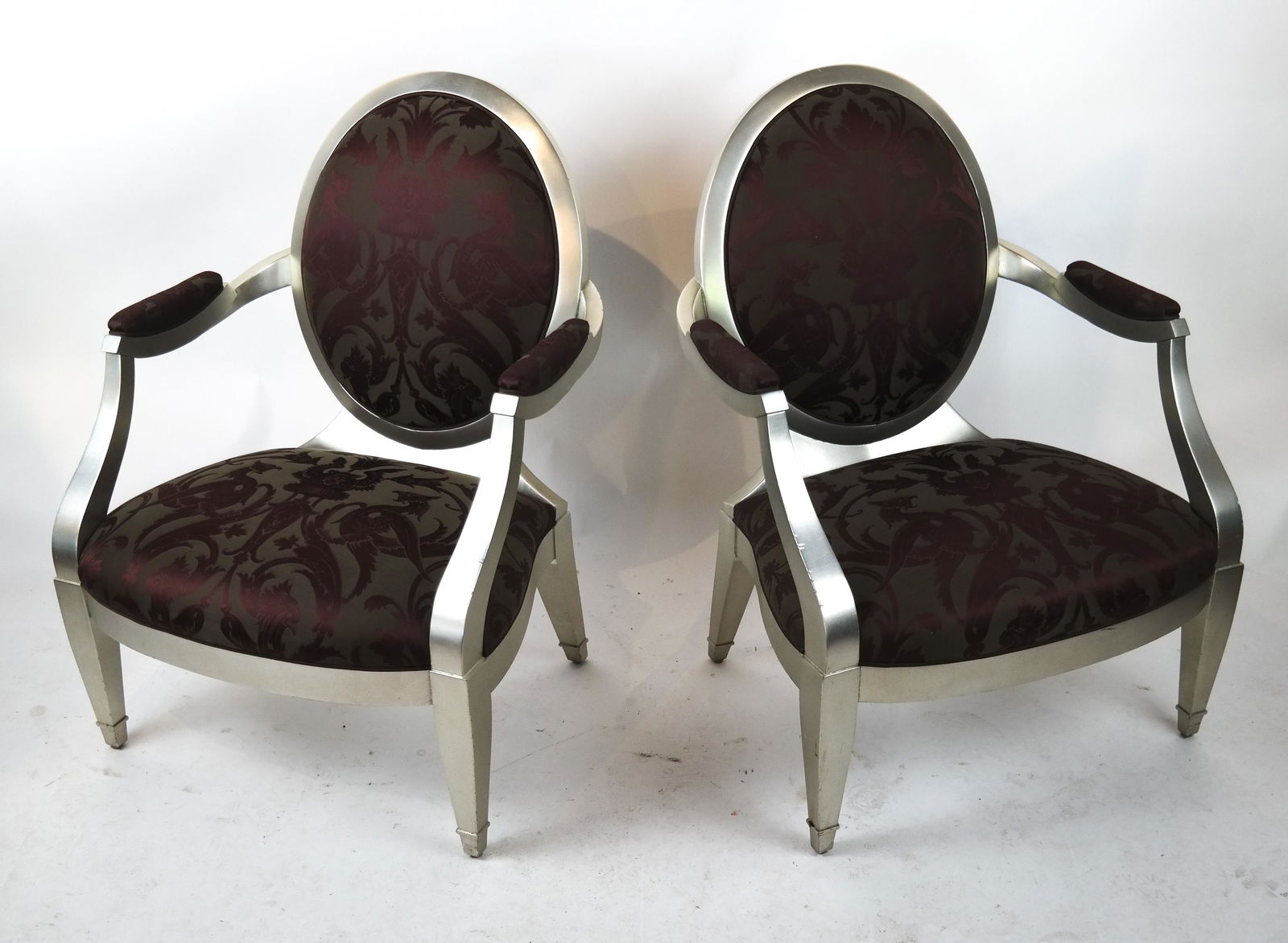 Pair of John Hutton for Donghia Arm Chairs: Pair of modern 21st century open arm chairs with maroon jacquard upholstery, bearing Donghia label beneath seat. [37 x 28 x 21 inches; 17 1/2 inches to seat]. In good condition.