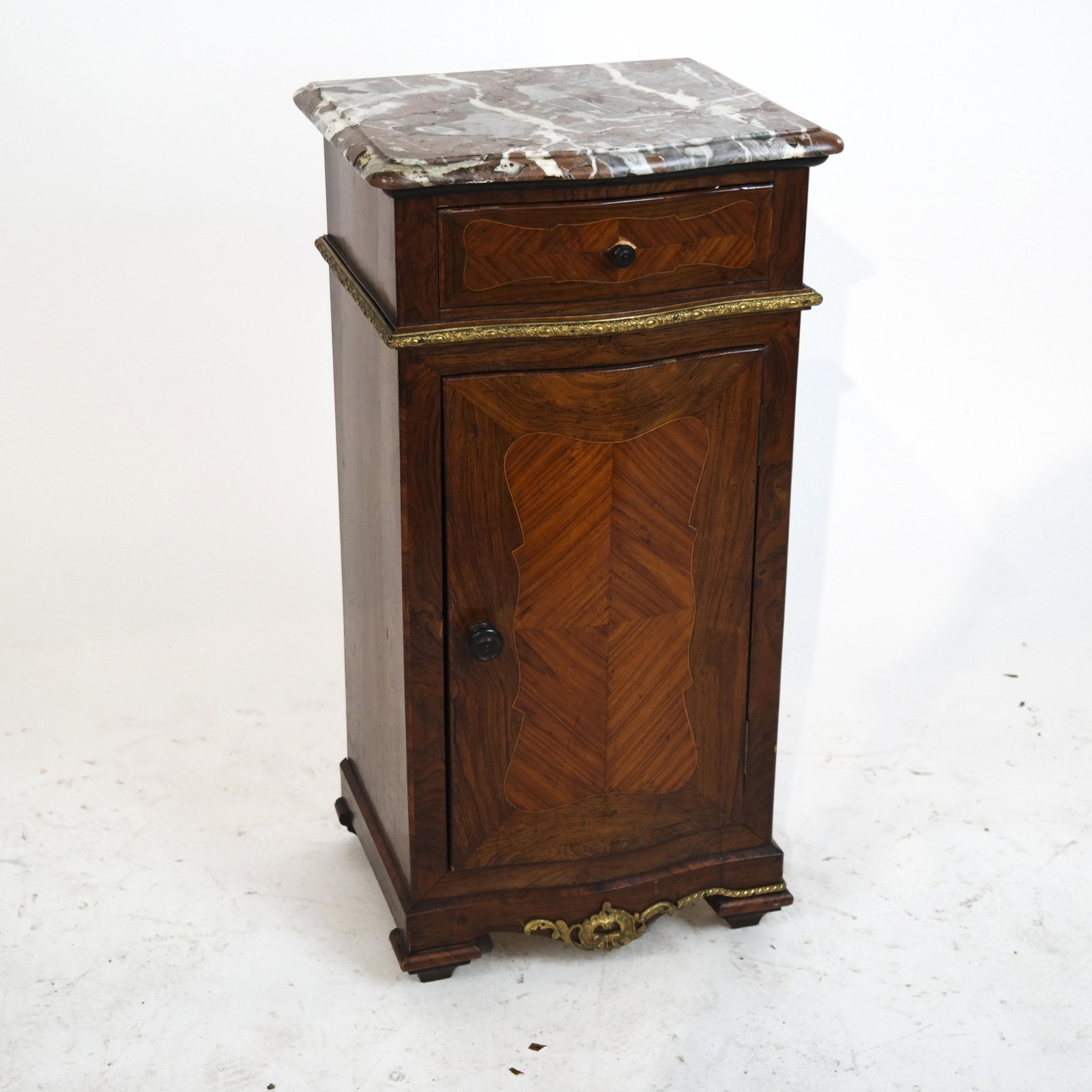 French 19th C. Rosewood Veneer Commode: French rosewood veneer commode, circa 1880, with veined marble top and bronze trim. [Overall: 30 1/2 x 15 1/2 x 13 inches].