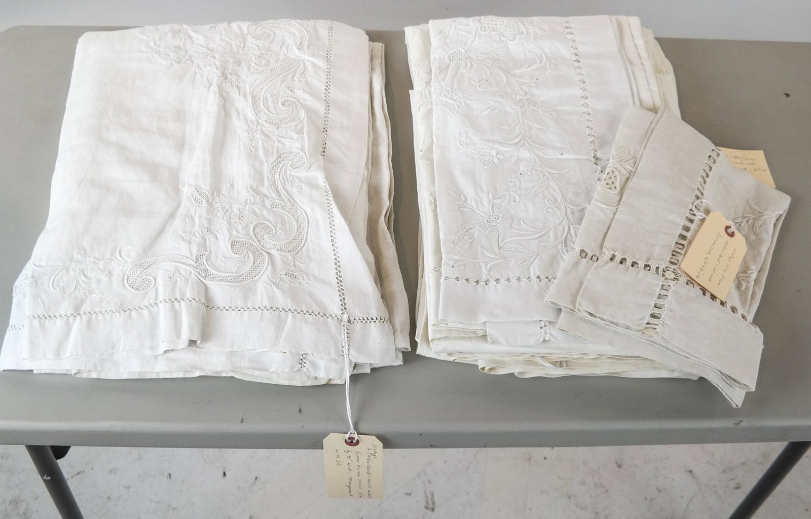 Vintage White Bed and Bureau Covers: Exceptional lot of mostly white, embroidered linen with needle and cut work on summer bed covers, bureaus and tables. Some of the seven pieces are monogrammed. The featured set is a heavy white linen 