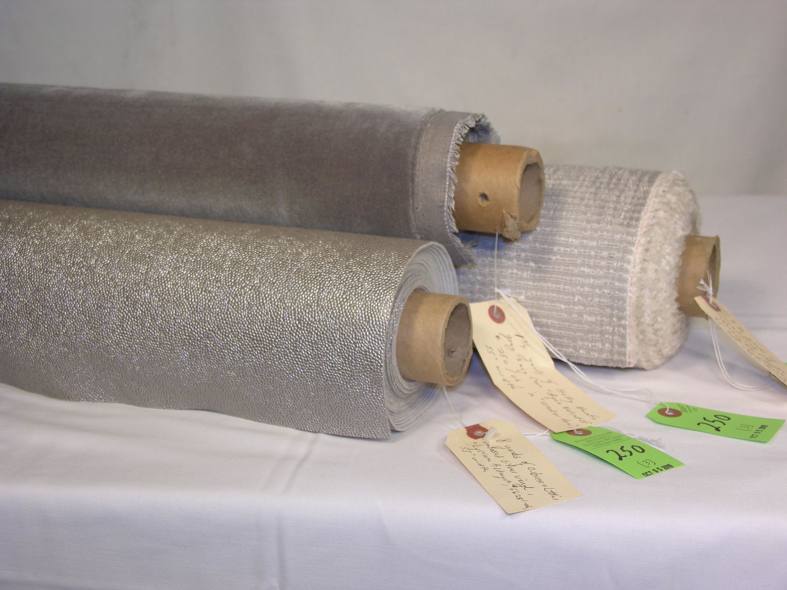 Osborne & Little, Holly Hunt and a Euro Texture: 1) 8 yards of Osborne & Little's heavy embossed upholstery vinyl in glamor silver "Lyceum Aldwych", #F6281-06. The faux lizard skin is 55" wide and ideal for family room stools. 2) 1 3/4 yards of Holl