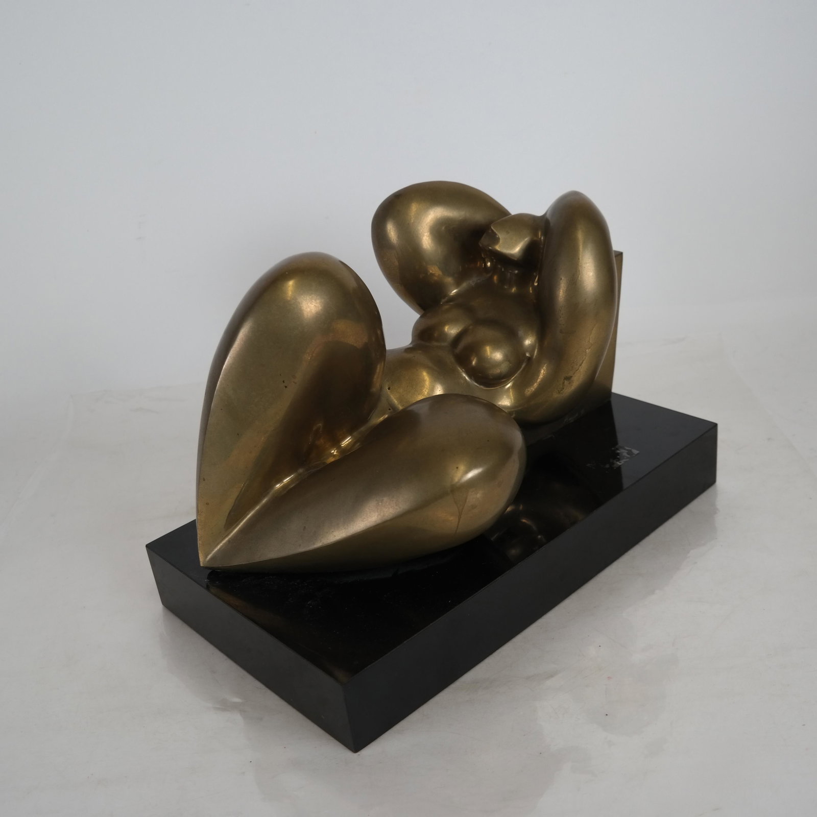 Frank PIAZZOLA: Abstract Female Nude Sculpture: Abstract reclining female nude sculpture, edition # 3/7, 1983. [9 1/2 x 14 x 8 1/2 inches]. Some wear to patina.