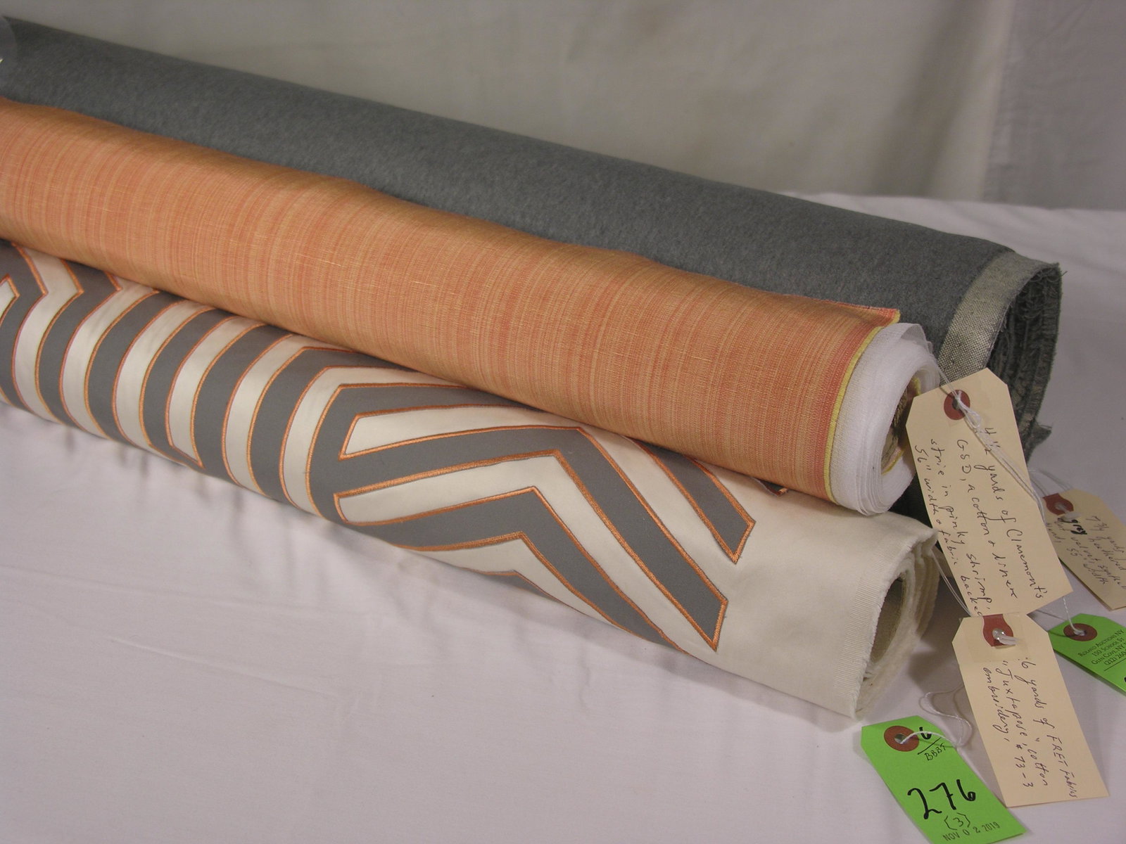 FRET, Claremont of England and Performance Velvet: 1) 6 yards of FRET Fabric's "Juxtapose", #73-3, an embroidered cotton applique in grey and orange on ivory. Repeats of 15 1/2 inches vertical by 27 1/2 inches horizontal across a 55-inch width. 2) 4 1