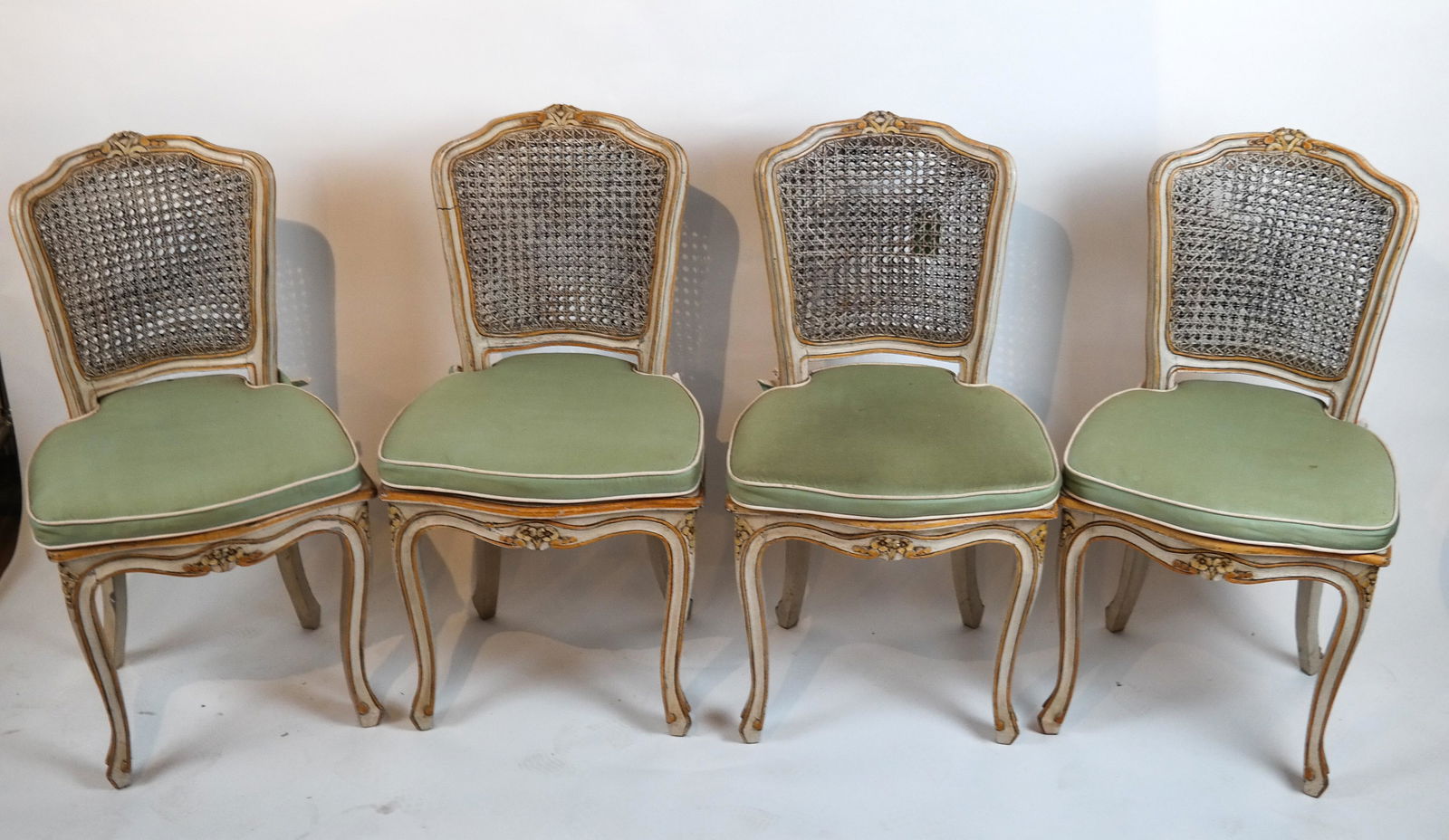 Set of 4 Creme Gilt Caned Side Chairs: Set of four creme gilt caned side chairs. [36 x 19 1/2 x 17 1/2 inches; 17 1/2 inches to seat]. All in good condition.