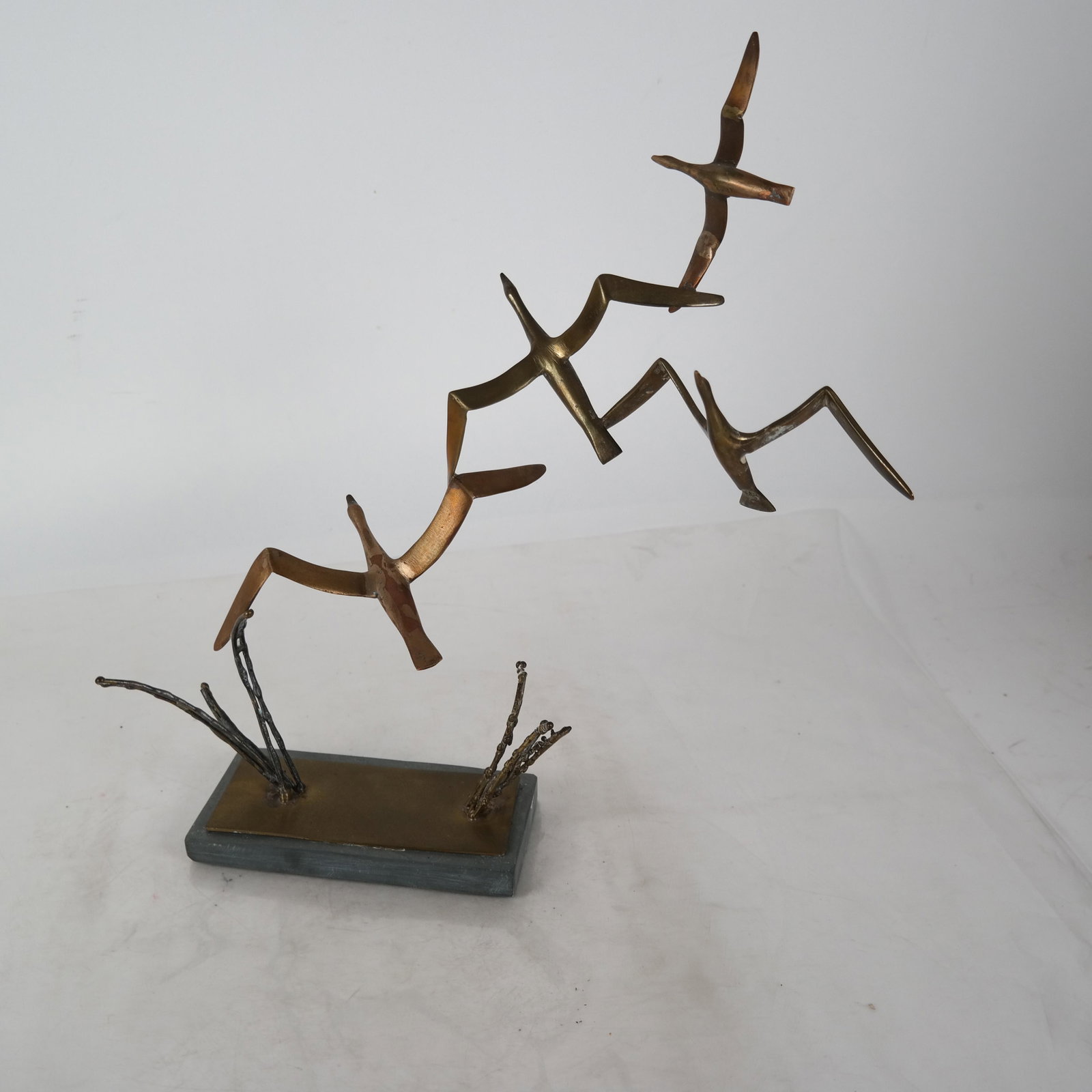J. NICKFORE: Brass Sculpture of Birds: Sculpture of birds in flight on a slate base. [15 x 14 x 4 inches]. In good condition.