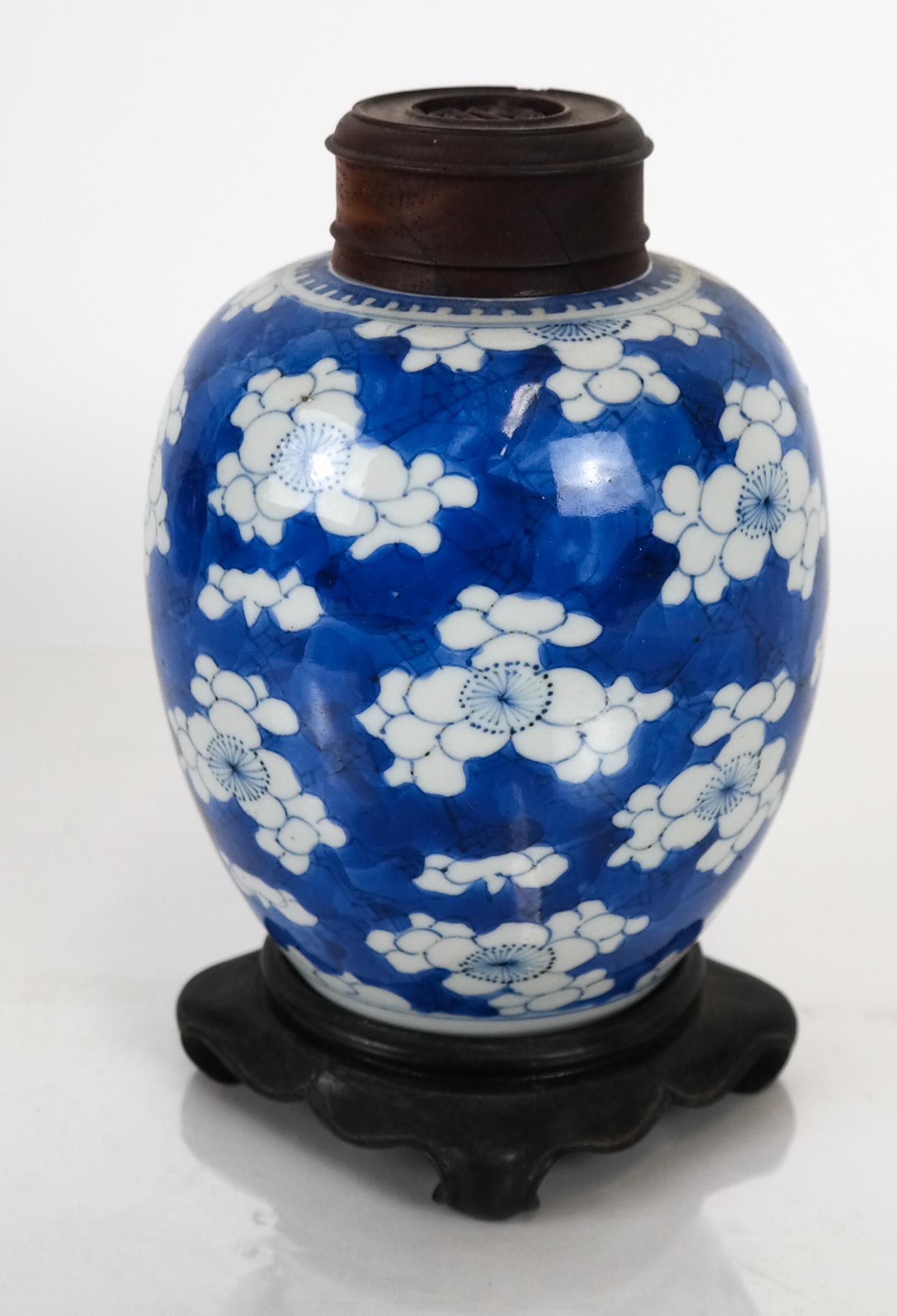 Chinese Blue & White Covered Ginger Jar: Chinese blue and white porcelain ginger jar with pierced wood lid, on wood stand. [Jar, without base: 6 x 4 (dia) inches].