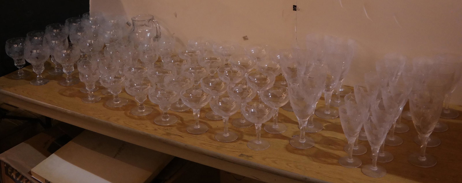Lot of Etched Crystal Stemware - 74 Pcs.: Stemware collection includes white wine, red wine, cordial, champagne coupe, sundae and sherbet glasses, in two different designs: Grapevine and Hops, with approx. 36 pieces in each pattern, plus a Gr