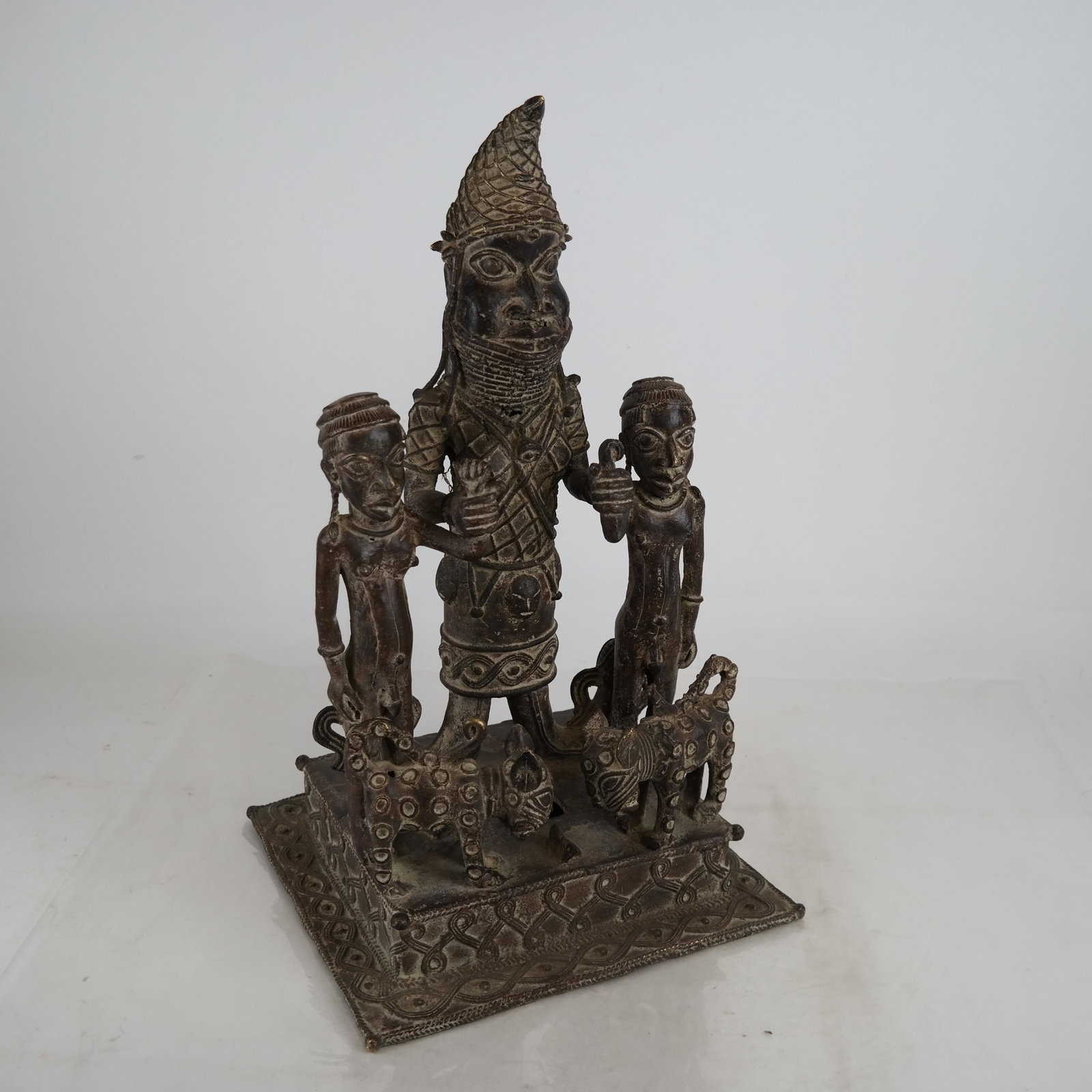 Bronze Sculpture Group: Figures, Animals: A bronze sculpture of a family and their pets. [18 x 10 1/2 x 9 1/2 inches]. In good condition.