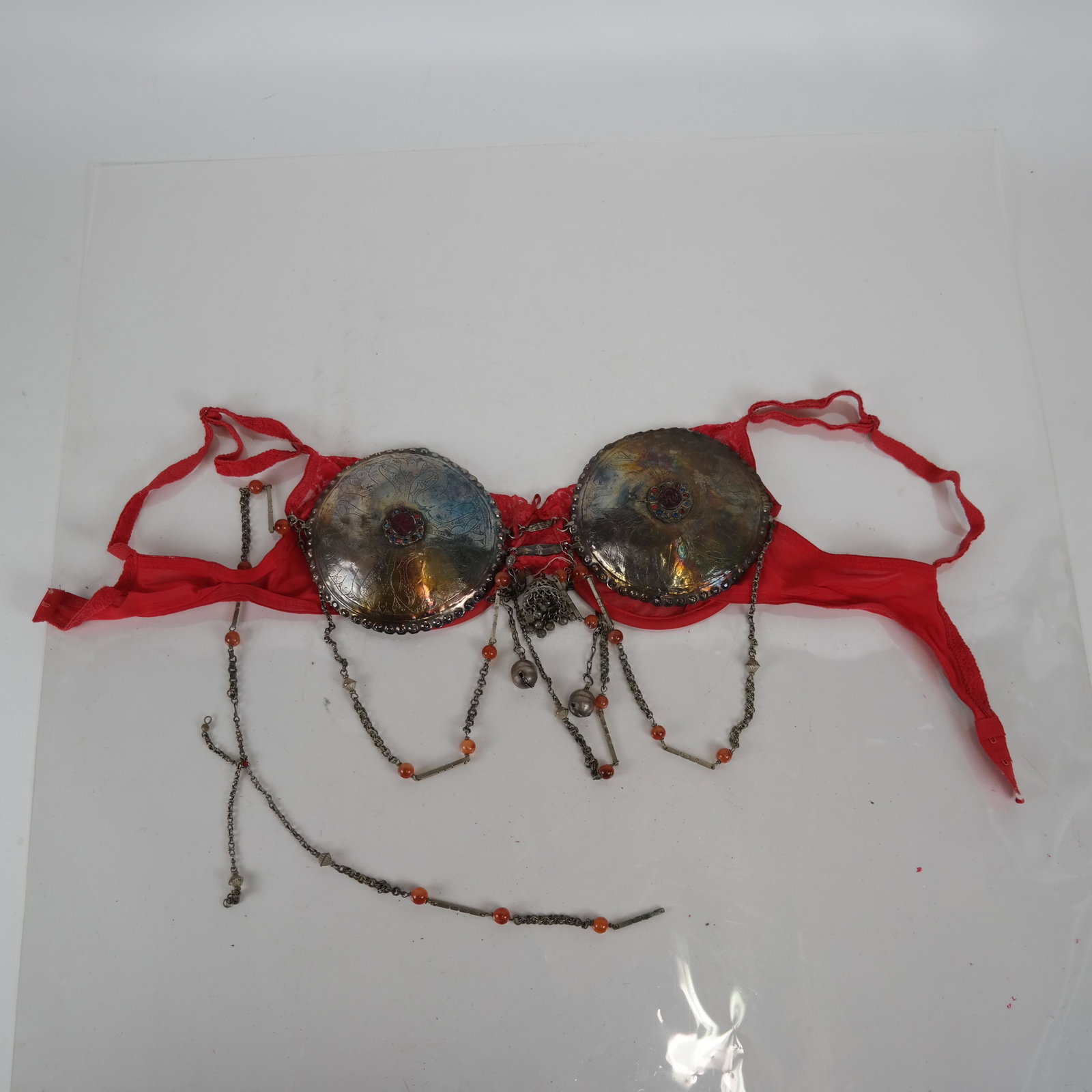 Silver Bra with Incised Decoration & Beads: Asian silver bra with incised decoration, embellished with carnelian beads, backed with a modern lacy red bra, size 38B. In good condition.