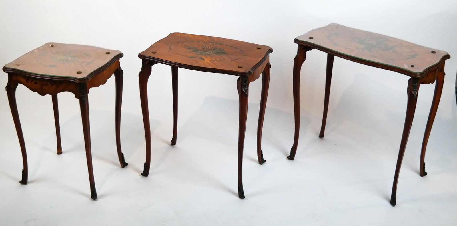 Nest of Three Floral Tables: Nest of three floral tables. [24 x 23 1/2 x 15 inches]. One of three tables in bad condition; others worn.
