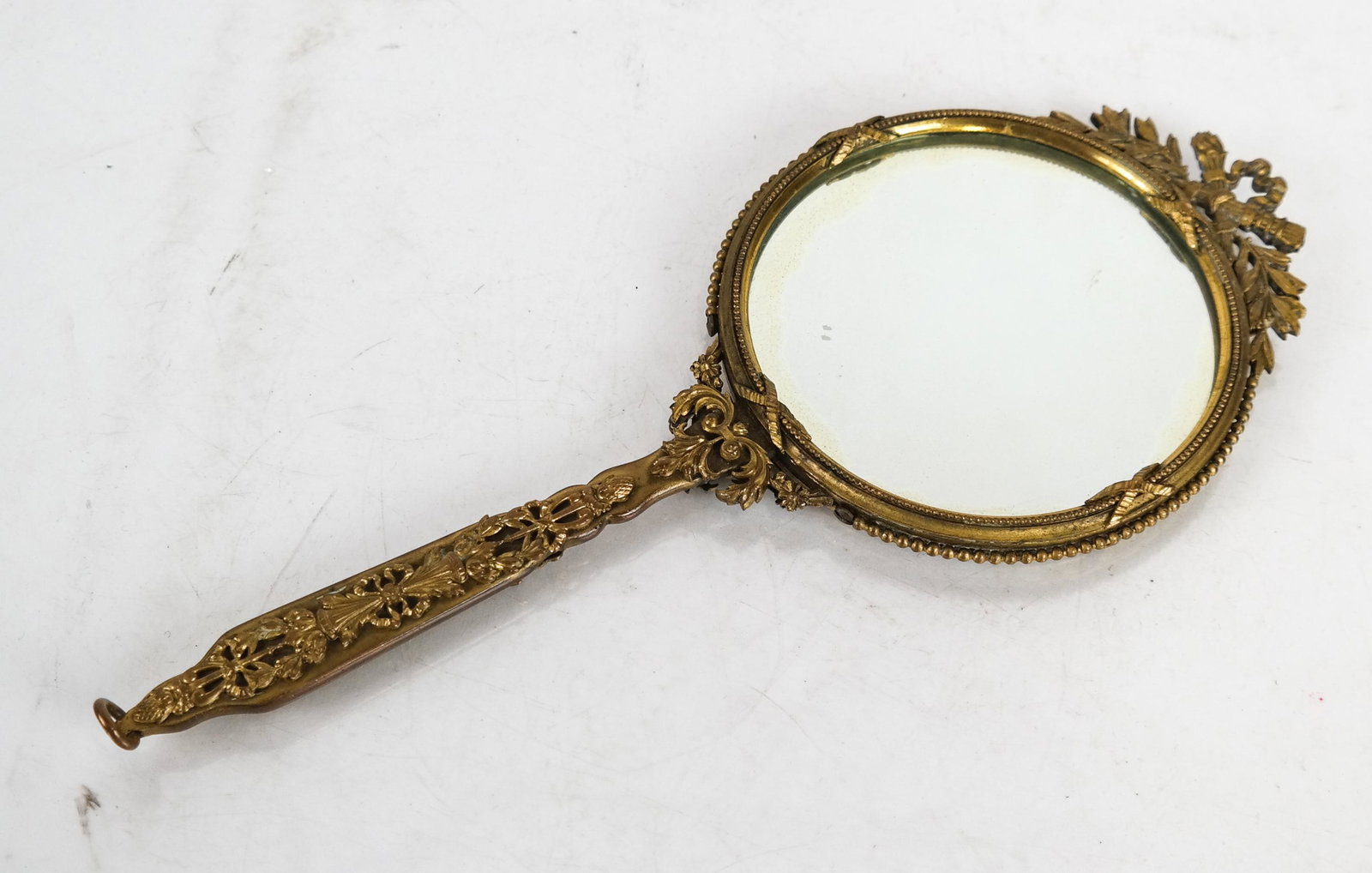 Bronze & Enamel Vanity Mirror: Bronze and enamel vanity mirror, having an ornate frame and portrait inset. [10 x 4 (dia) inches]. In good condition.