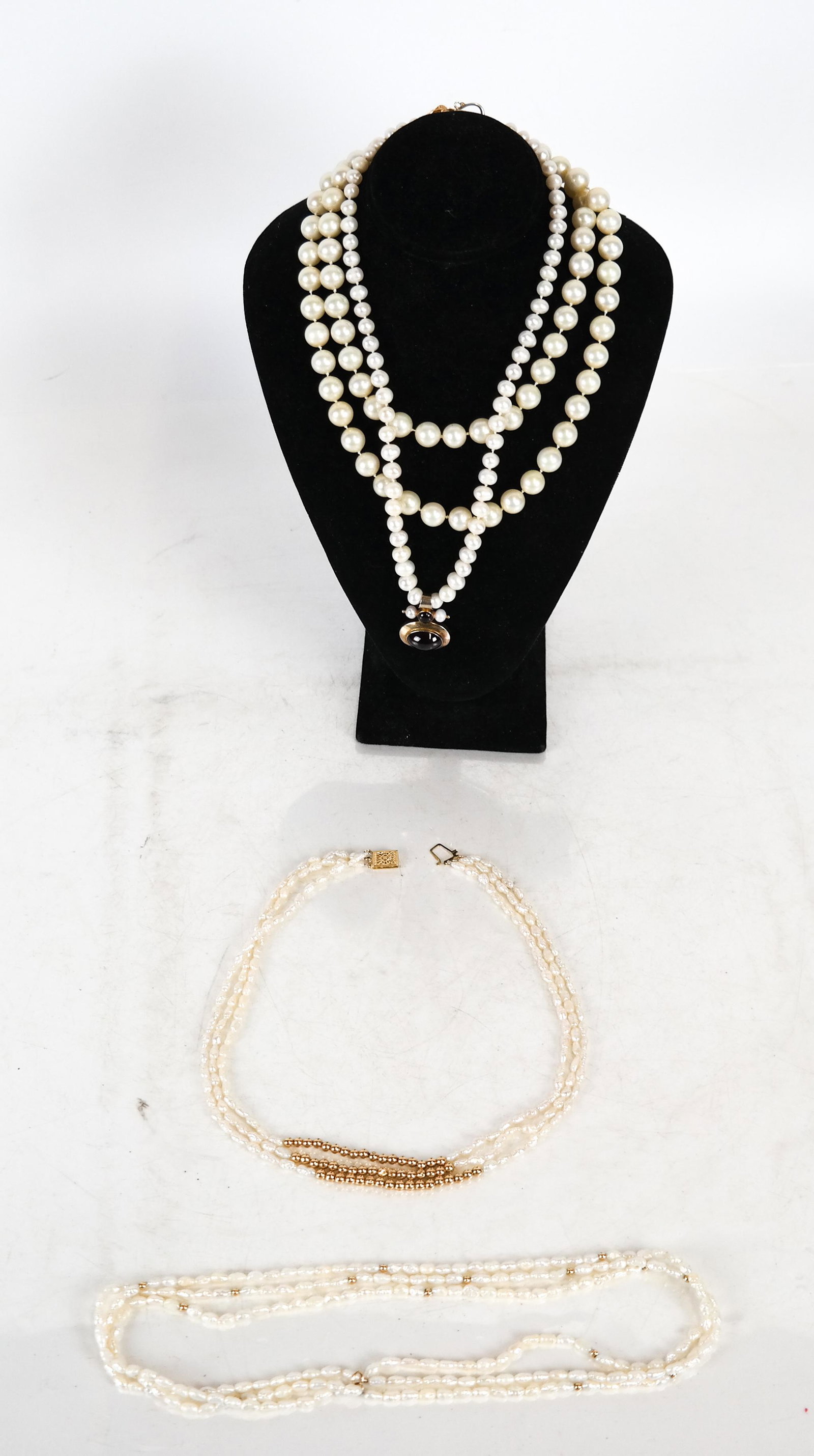 Four 14K & Sterling Pearl Necklaces: 1) Gilt .925 silver pendant "MMA" [18 inches]; 2) rice pearls choker with14K gold beads and clasp [17 inches]; 3) rice pearl choker with beads ]18 inches], and 4) single strand with 14K rosette clasp 